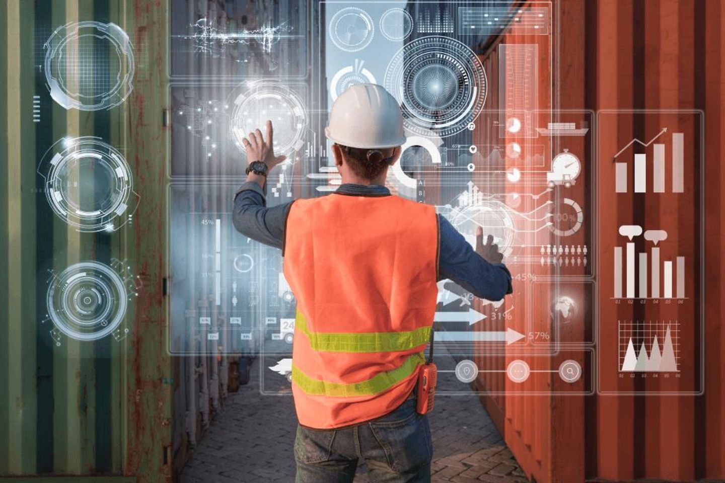 Man with protective clothing operates VR Screen, in the background are containers