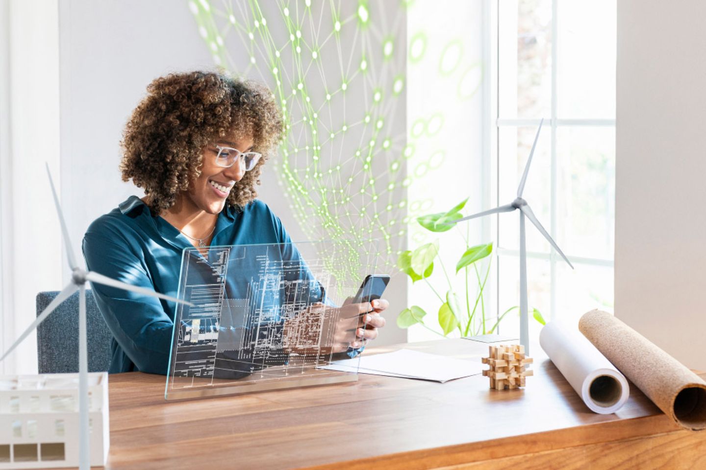 A woman sits at a desk and uses a smartphone, with a green net structure emerging from it