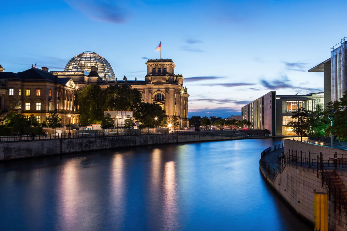 Berlin - Reichstag building/German parliament on the Spree river at dusk.