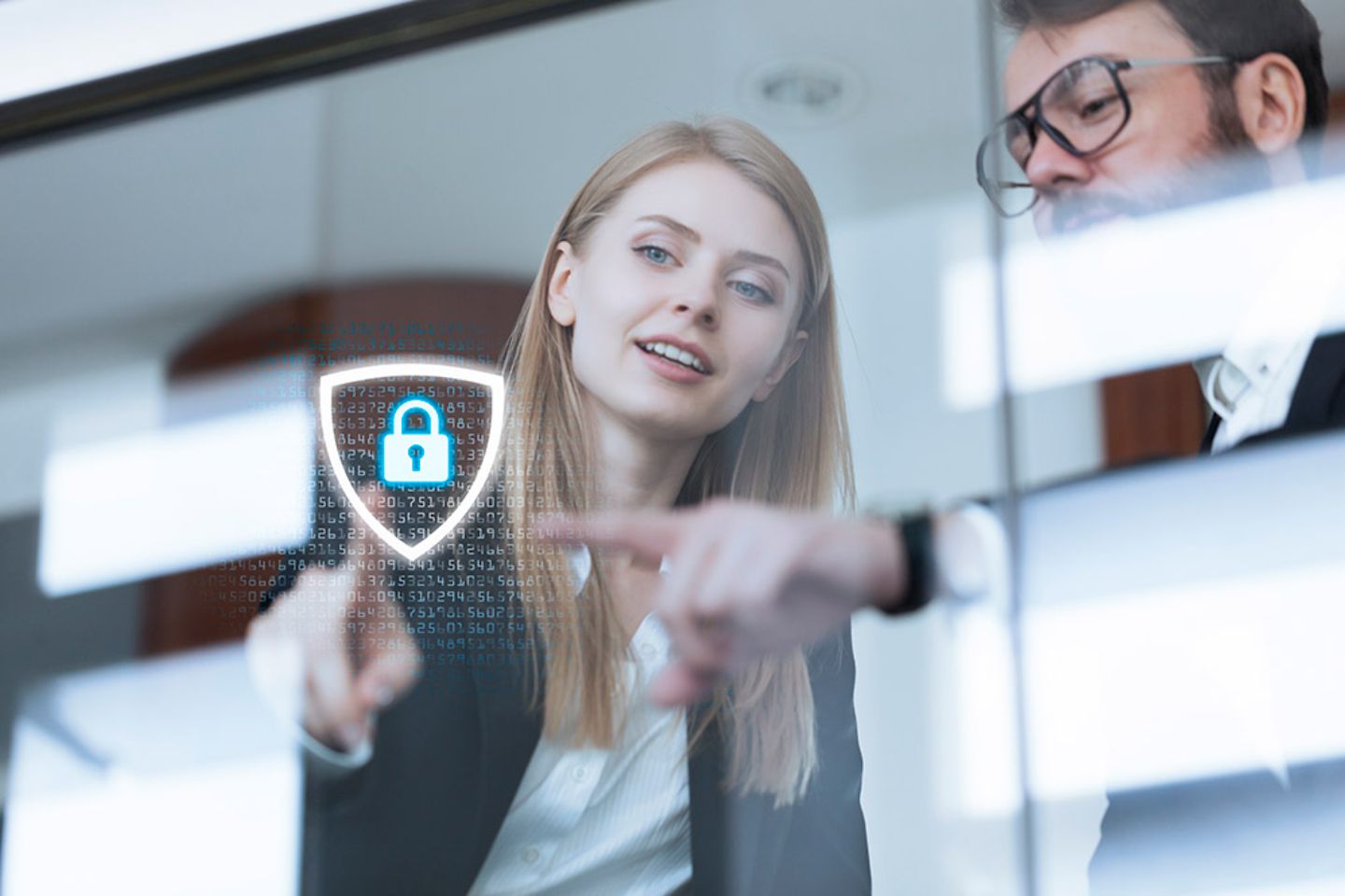 A man and a woman point to a digital lock