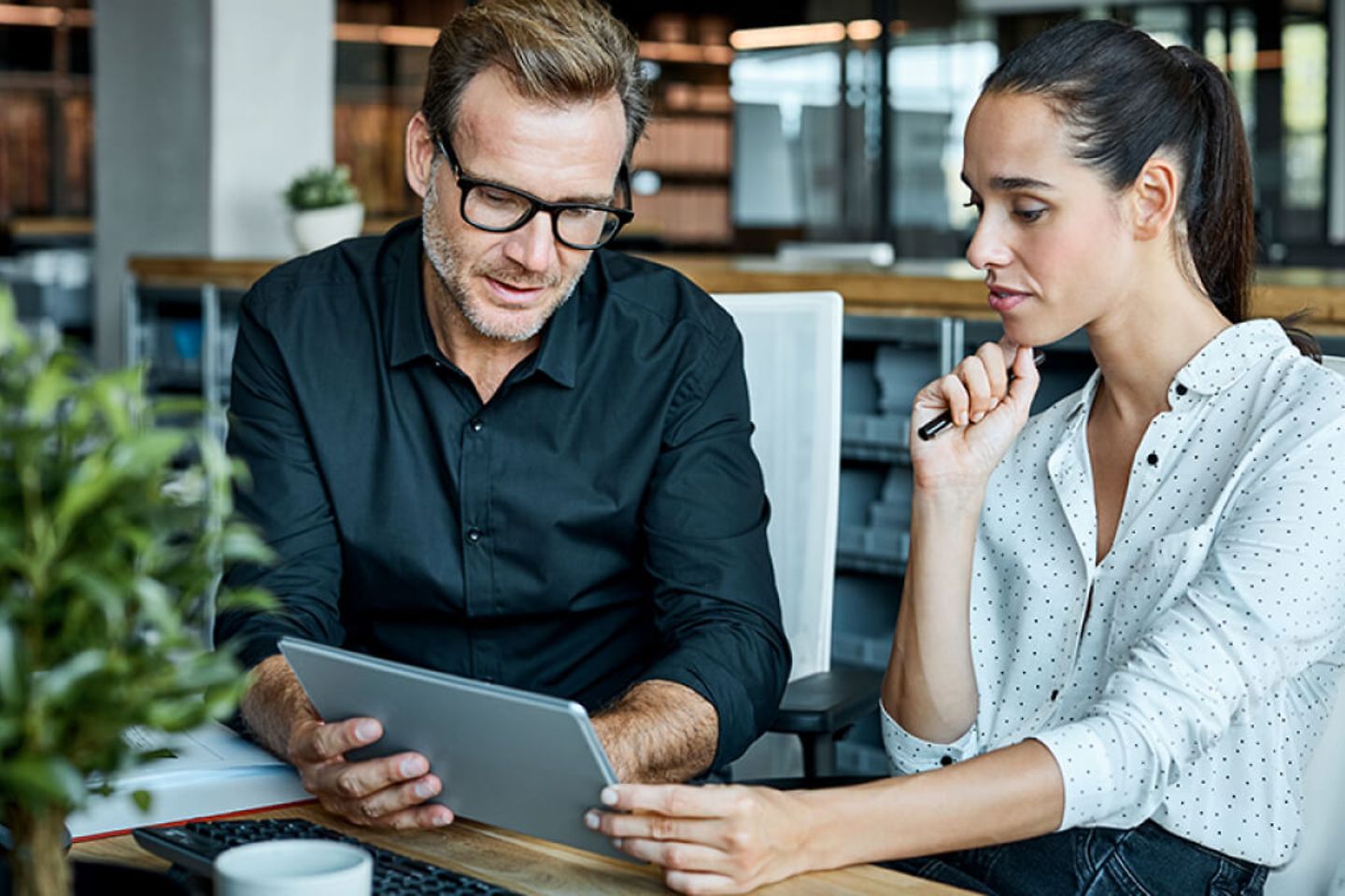 Arbeitskollegen schauen auf Tablet-PC