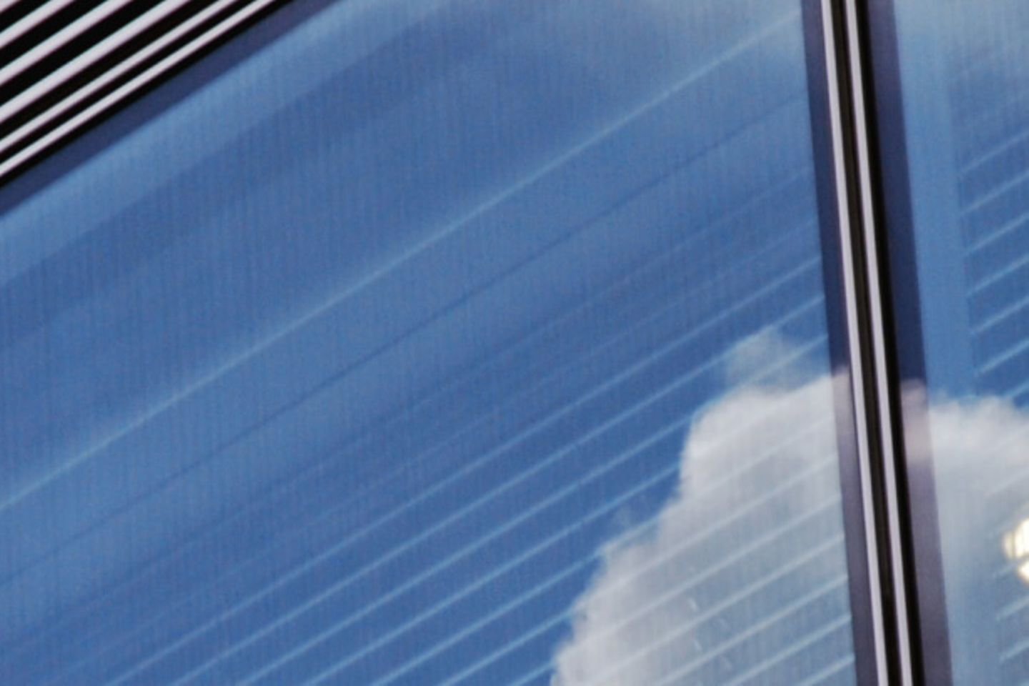 Clouds reflecting in a building window 