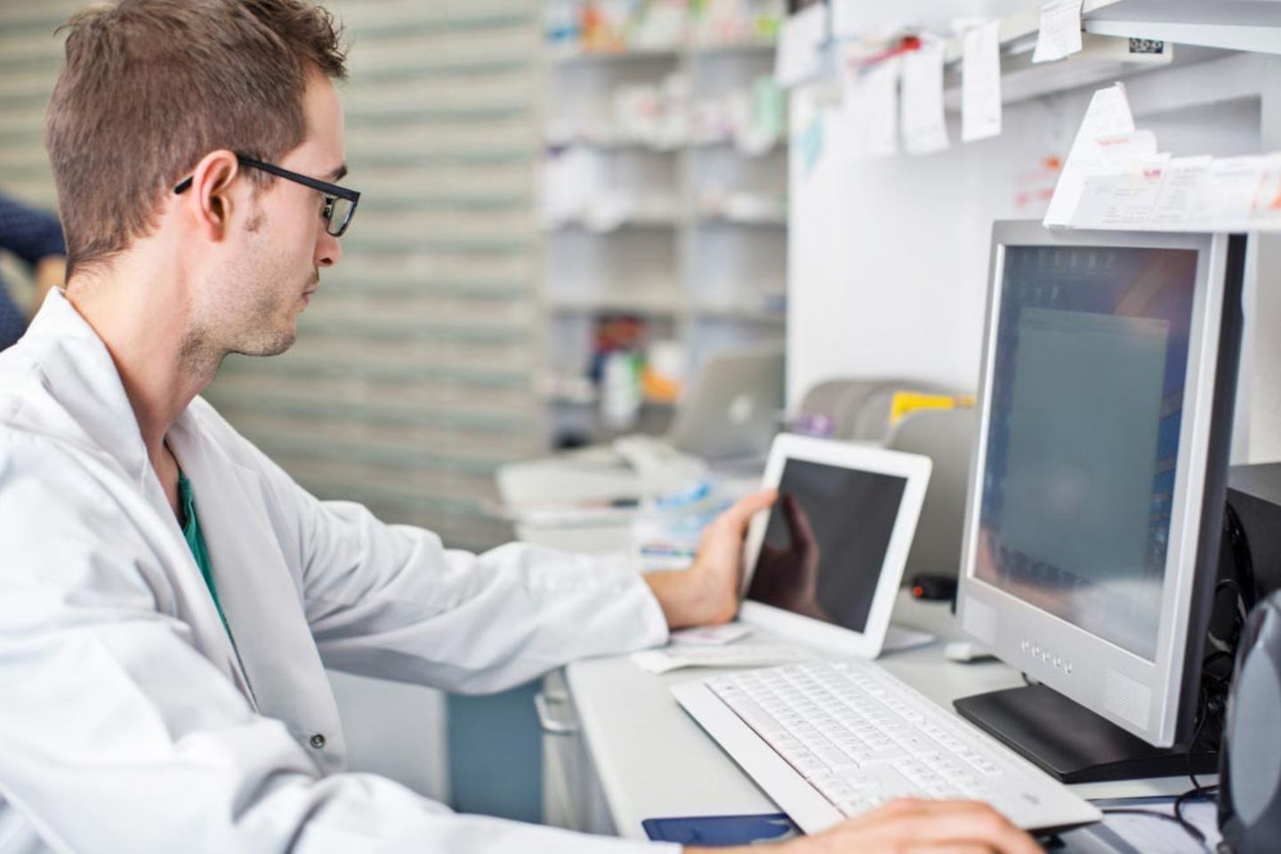 Doctor working on a computer and tablet