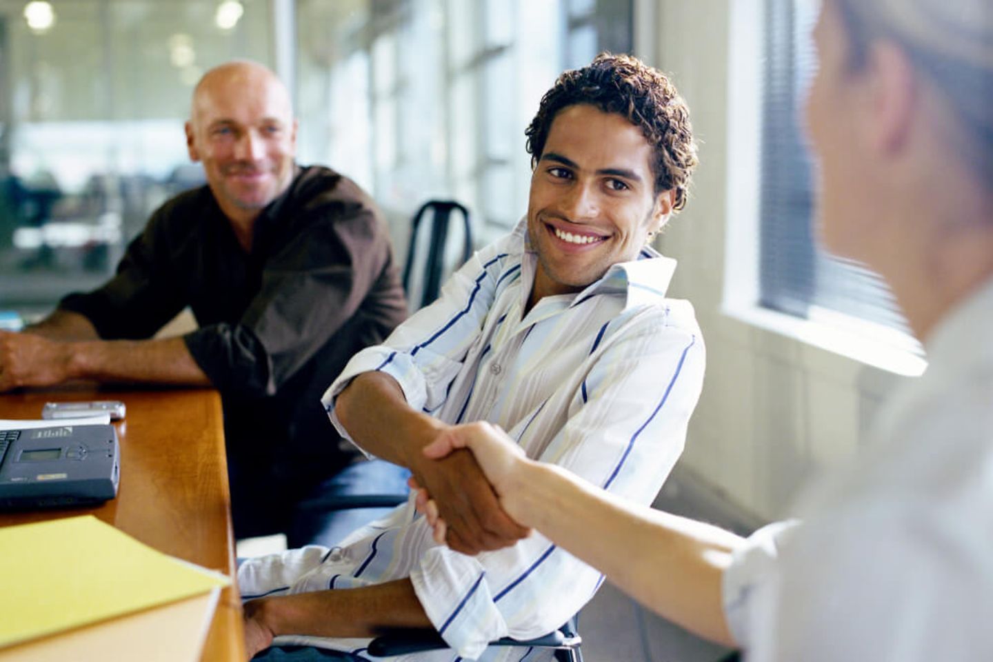 Smiling Business Man shakes hand to a Women