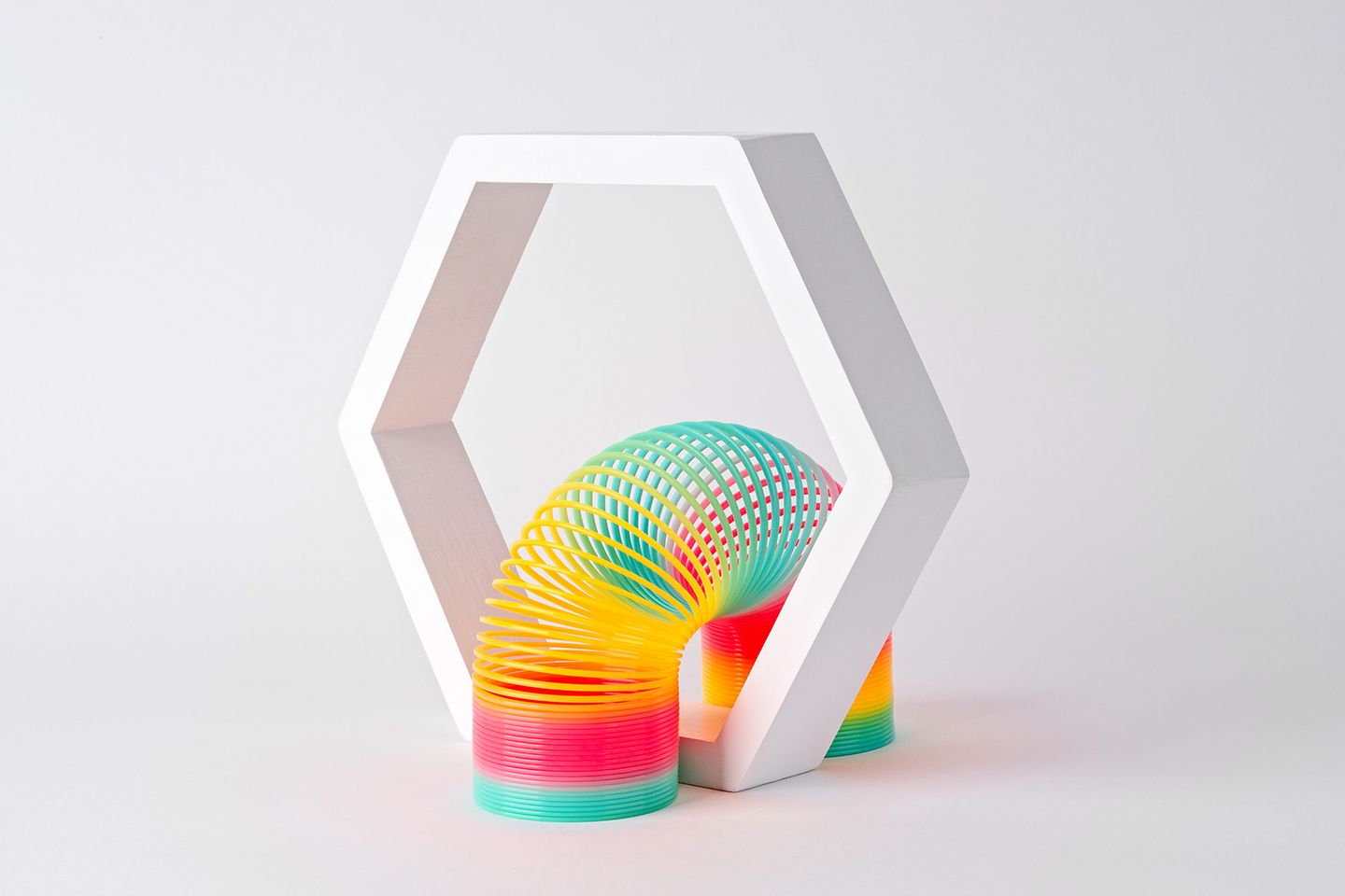 A multicolored slinky in an octagon.