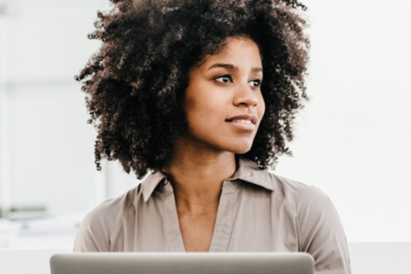 Woman sitting with a laptop in her hands.