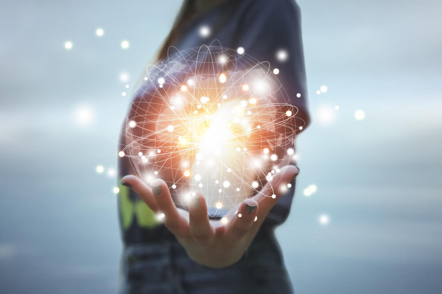 A woman holds a digital sphere in her hands