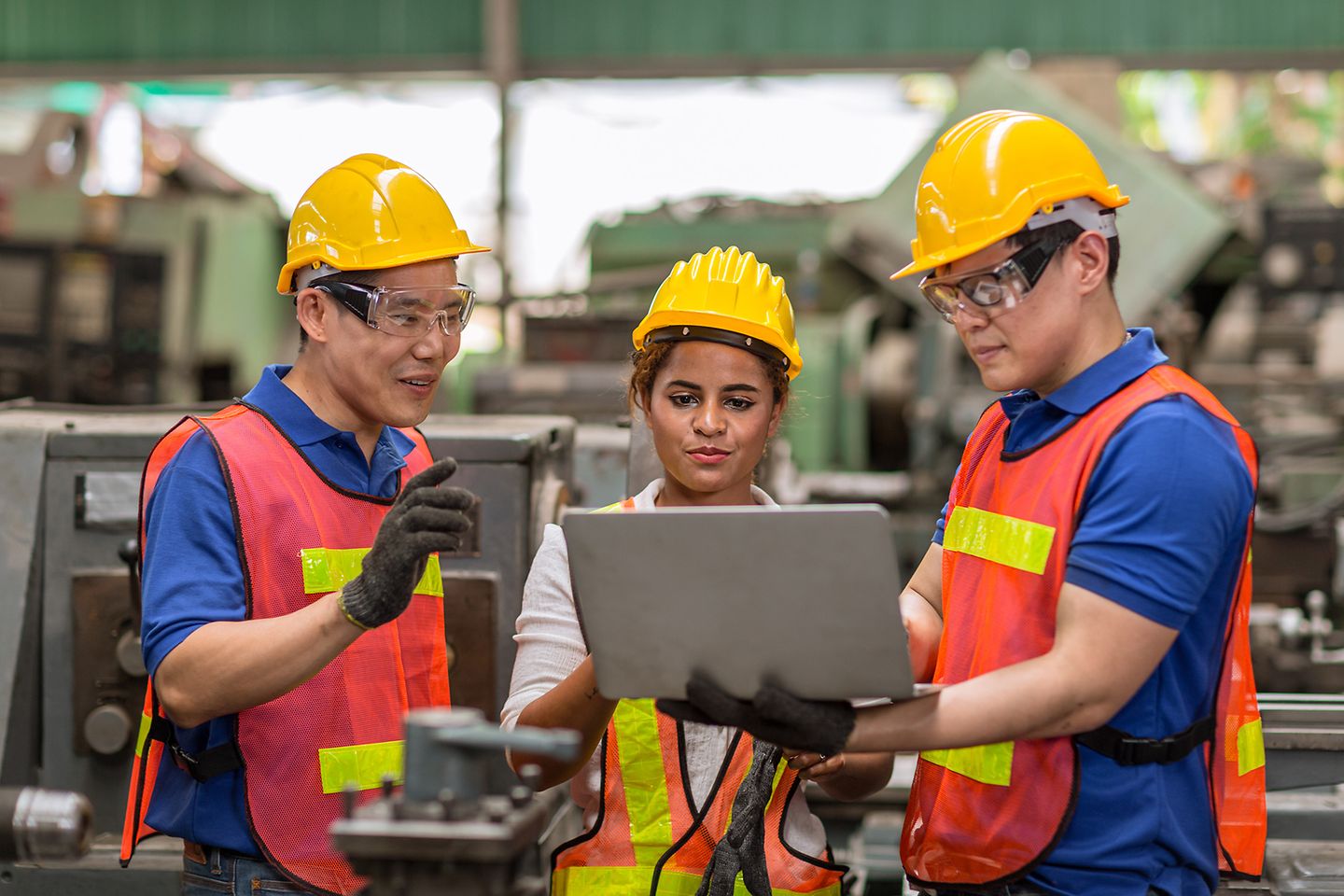 engineer women working heavy industry with laptop discussion