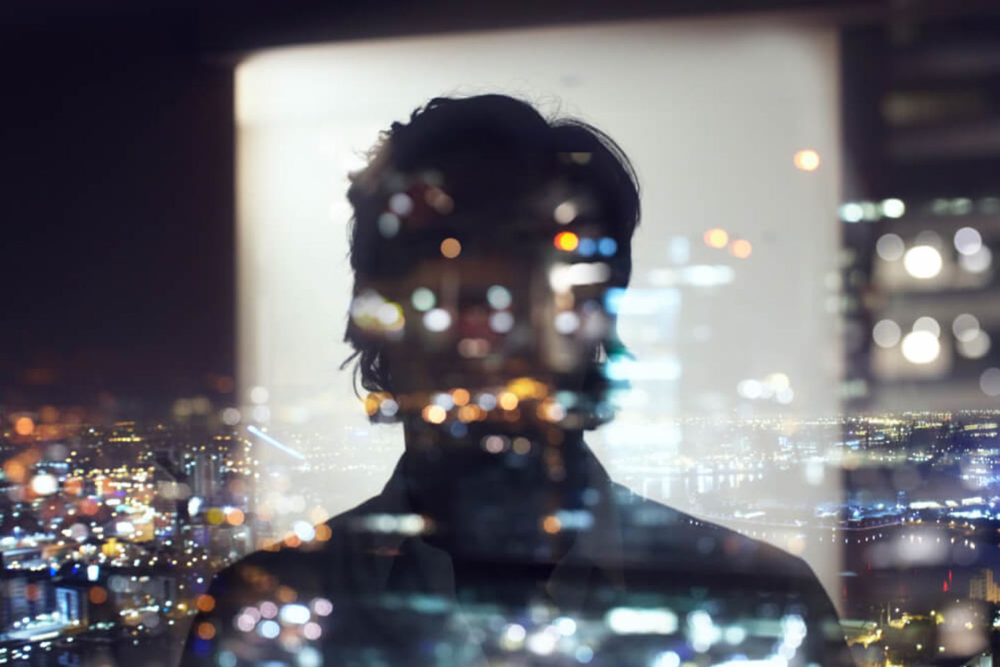 reflection of person at night with city lights