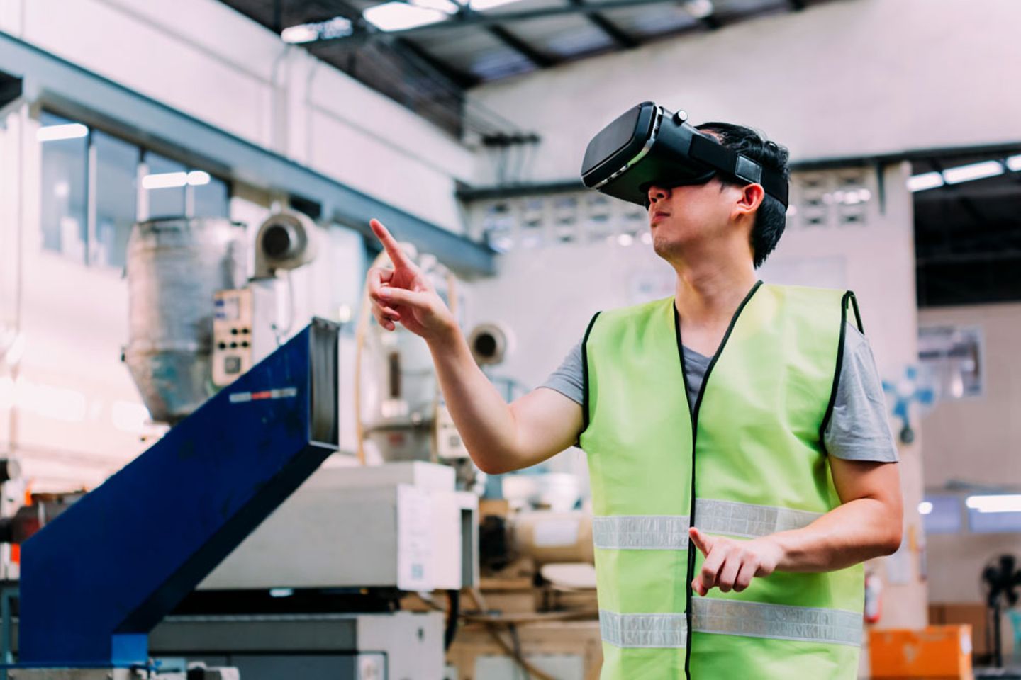 Industrial factory manufacturing worker wearing VR headset