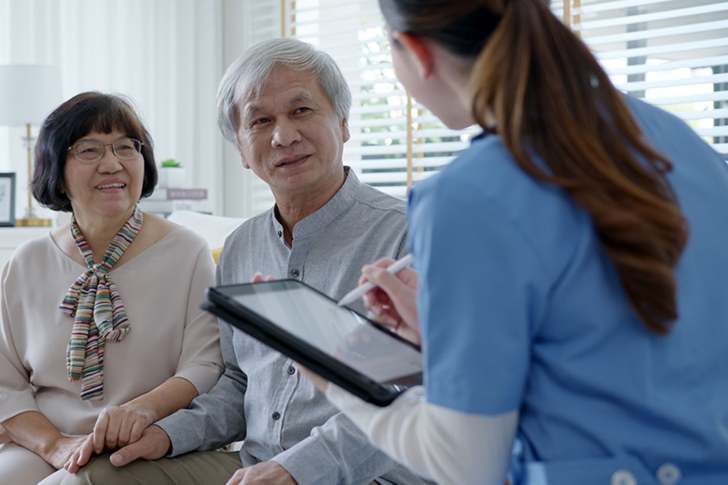 Senior couple consulting physician with digital tablet for healthcare
