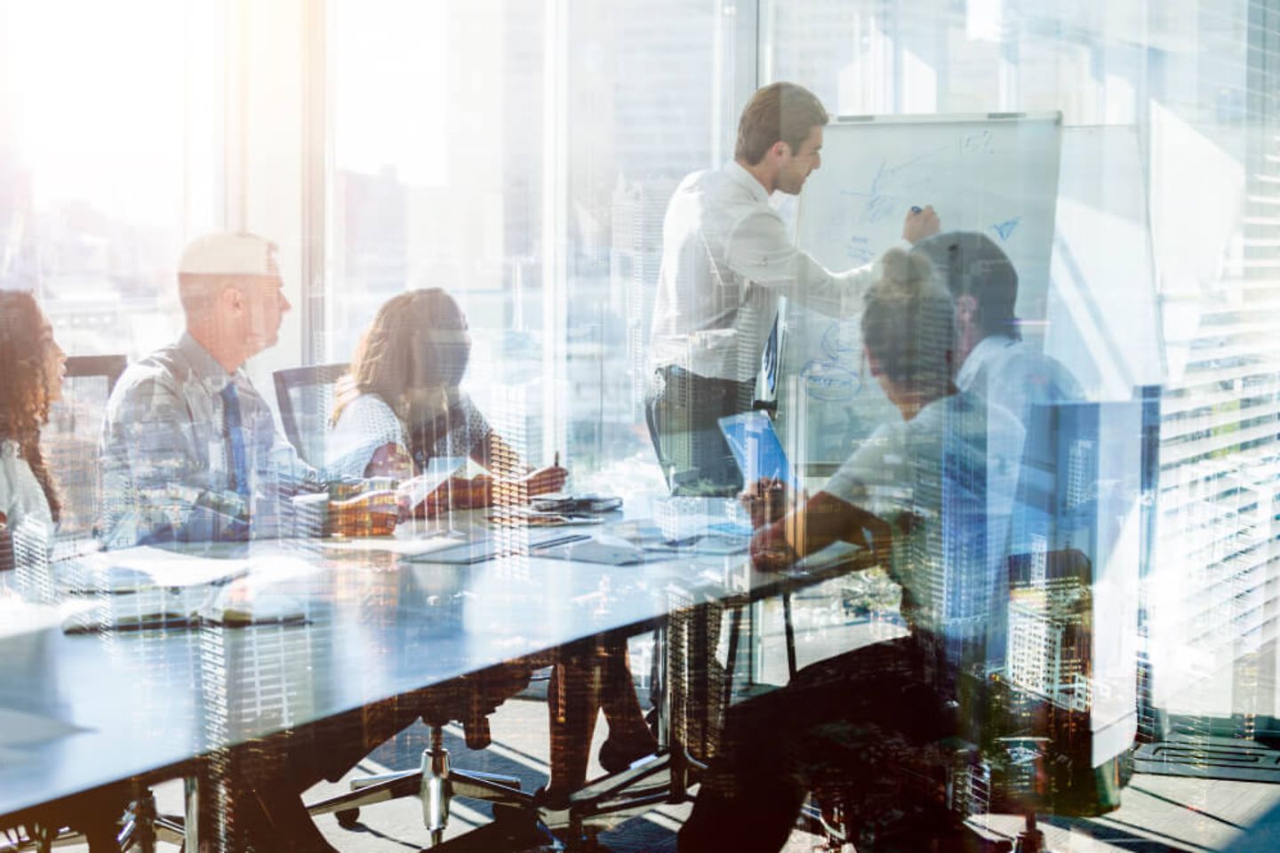 Montage of a team of business people at a presentation at the boardroom tabl