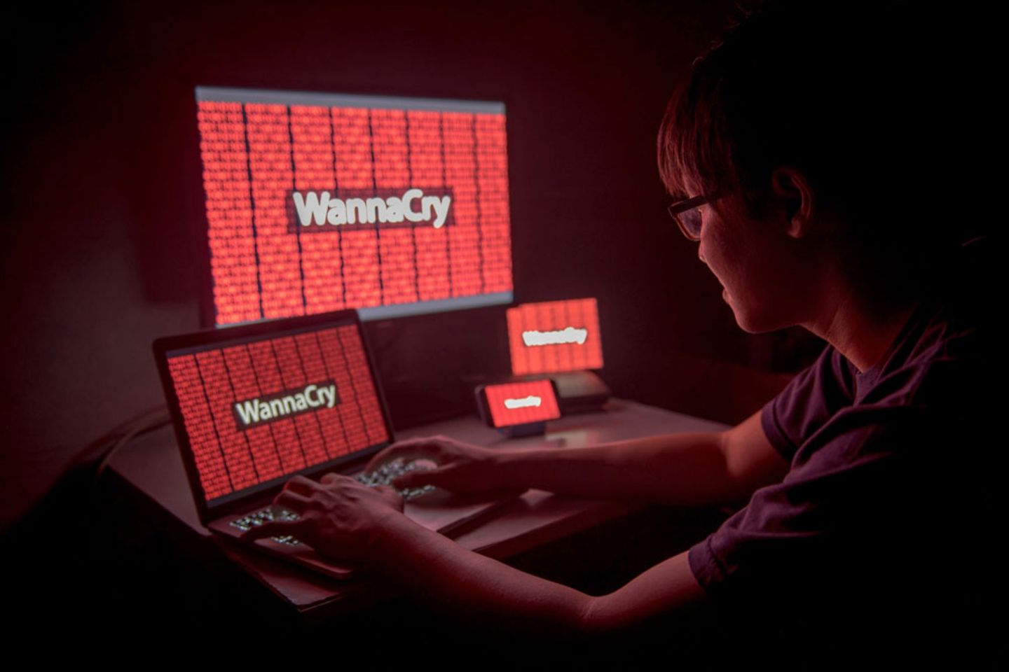Worker frustrated and confused by WannaCry ransomware attack on desktop screen