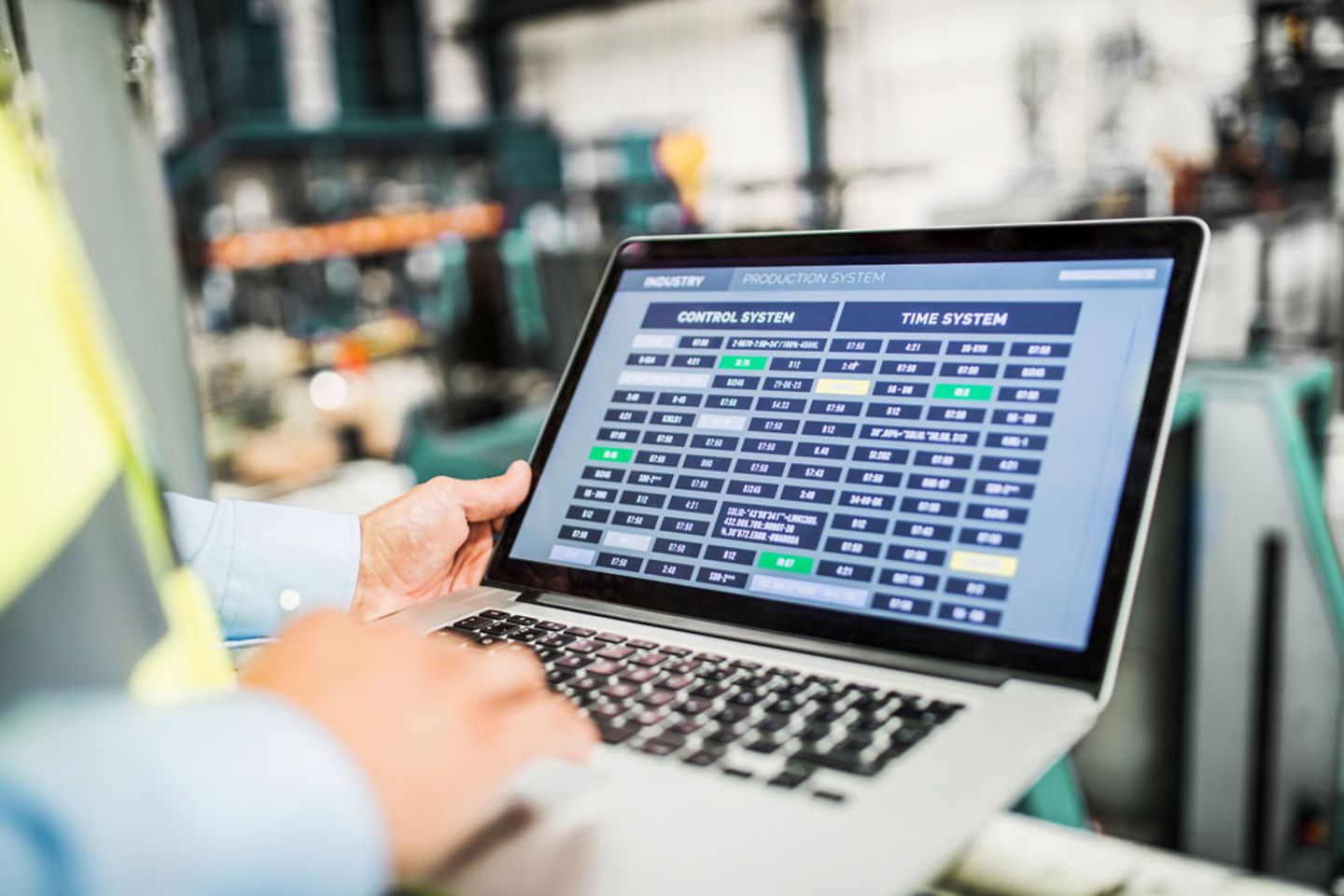 engineer with laptop in a factory, working