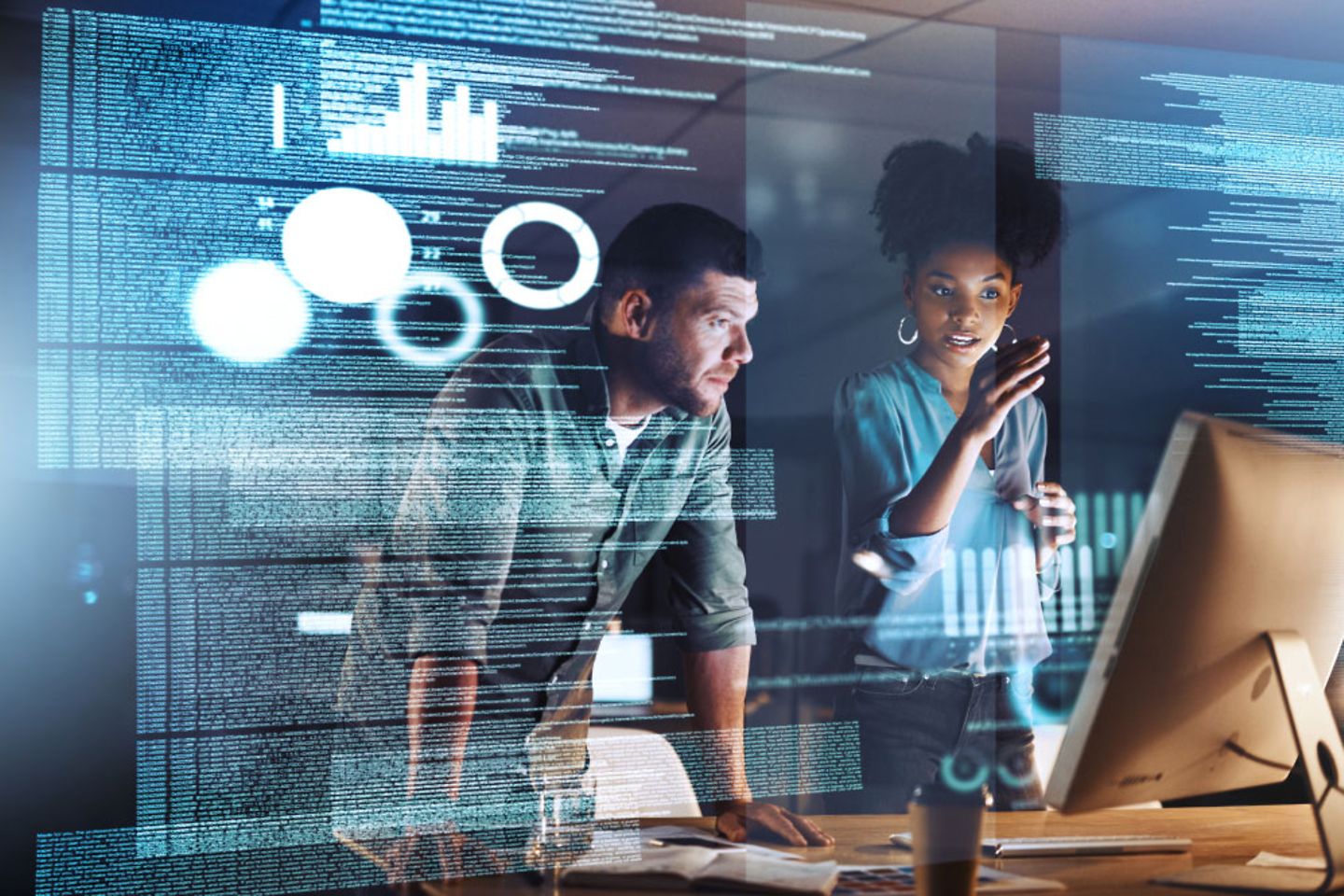 A man and women look at a monitor