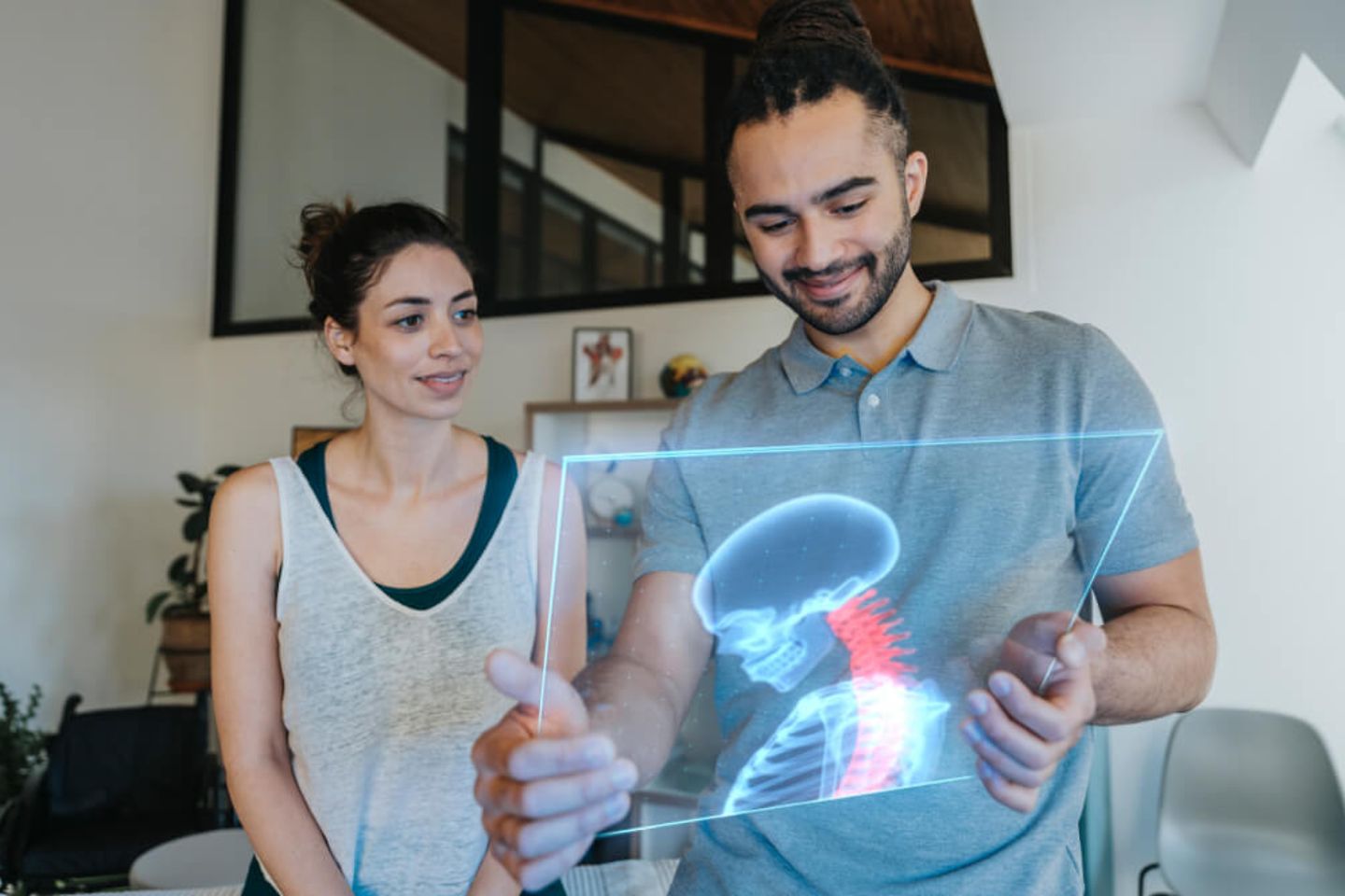 couple looking at anatomical model on transparent screen