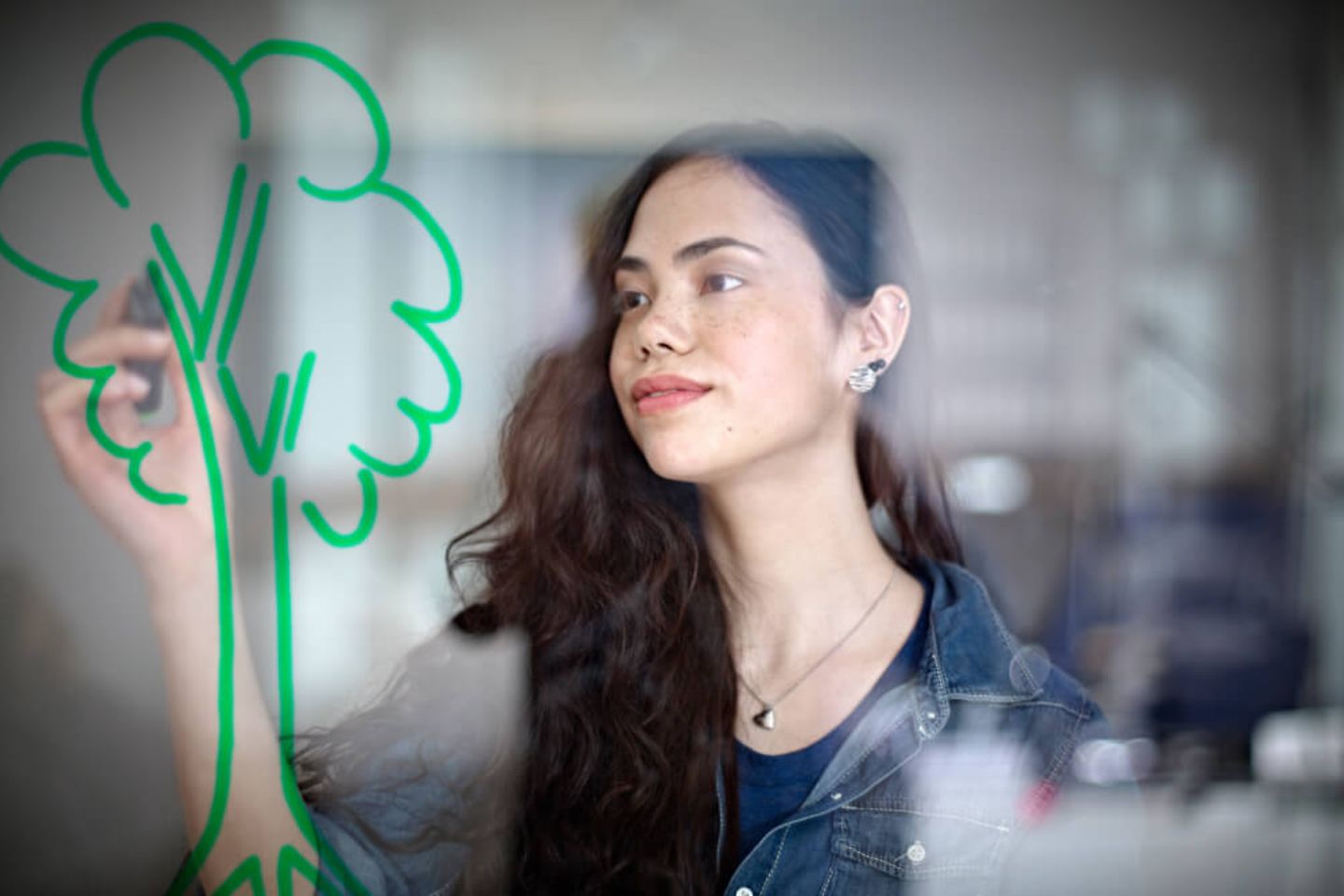 A woman painting a tree.