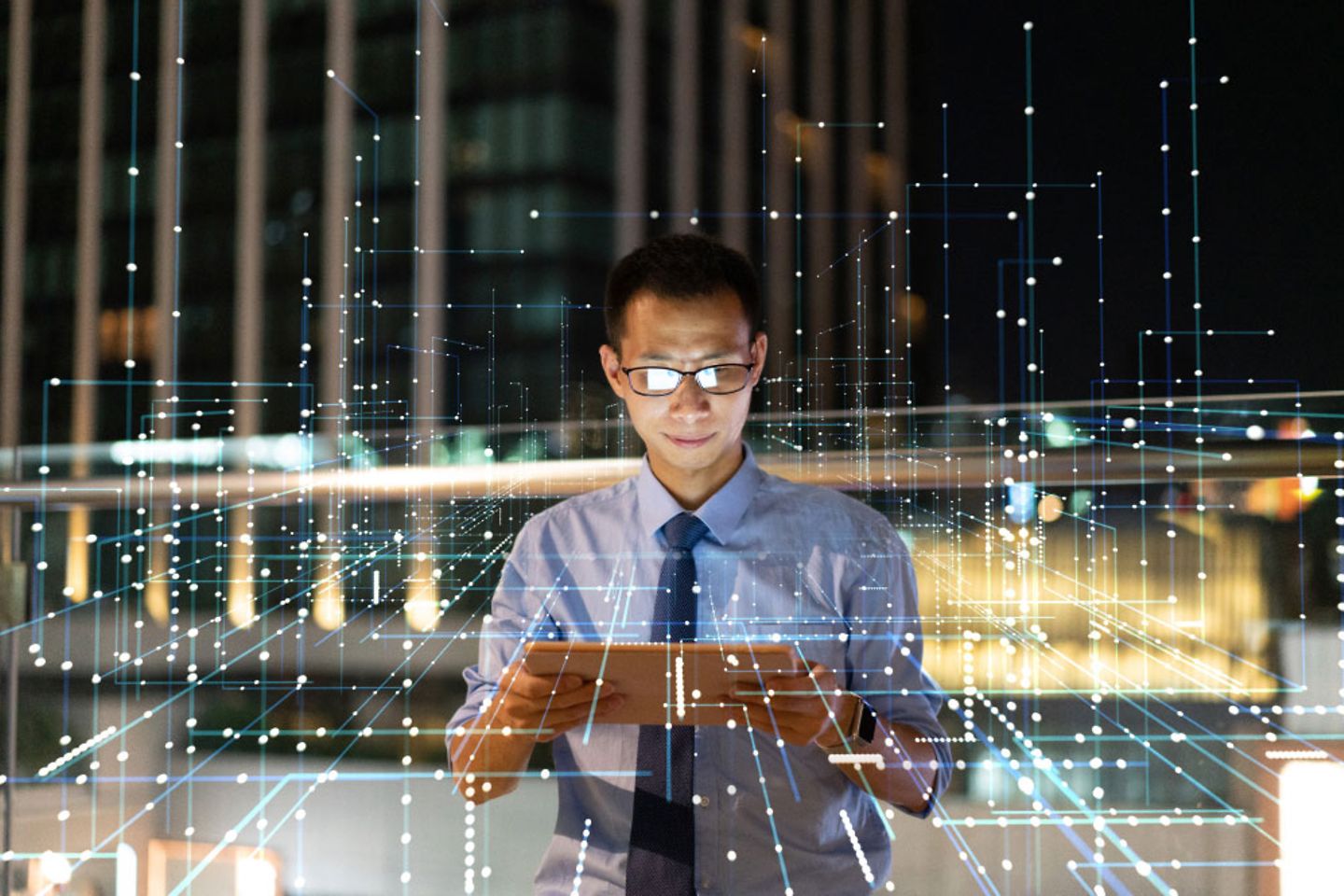 Businessman looking at something on tablet with glowing network overlay