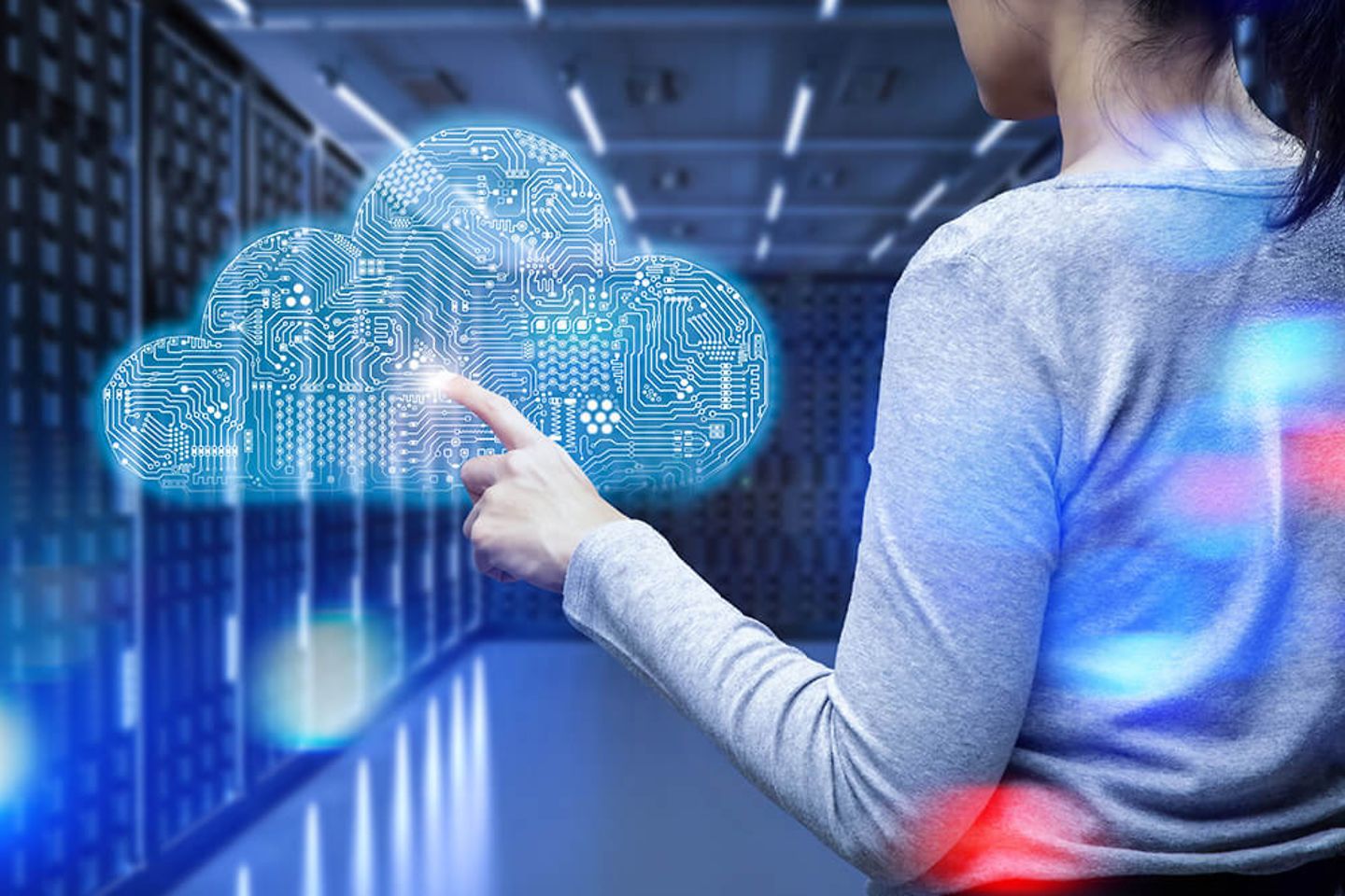 woman points at holographic cloud in server room