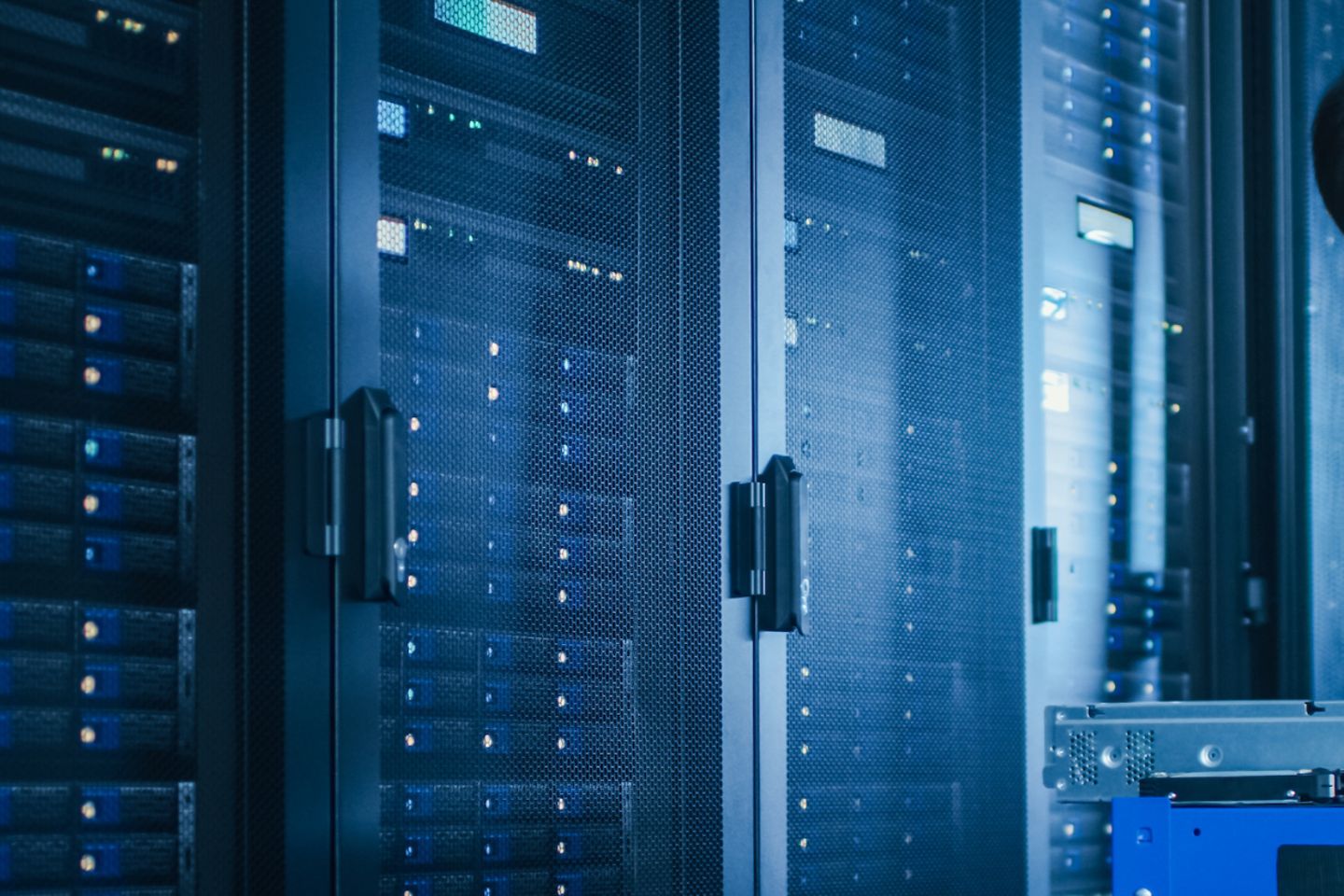 IT Technician Working with Server Racks, on a Pushcart Installing New Hardware