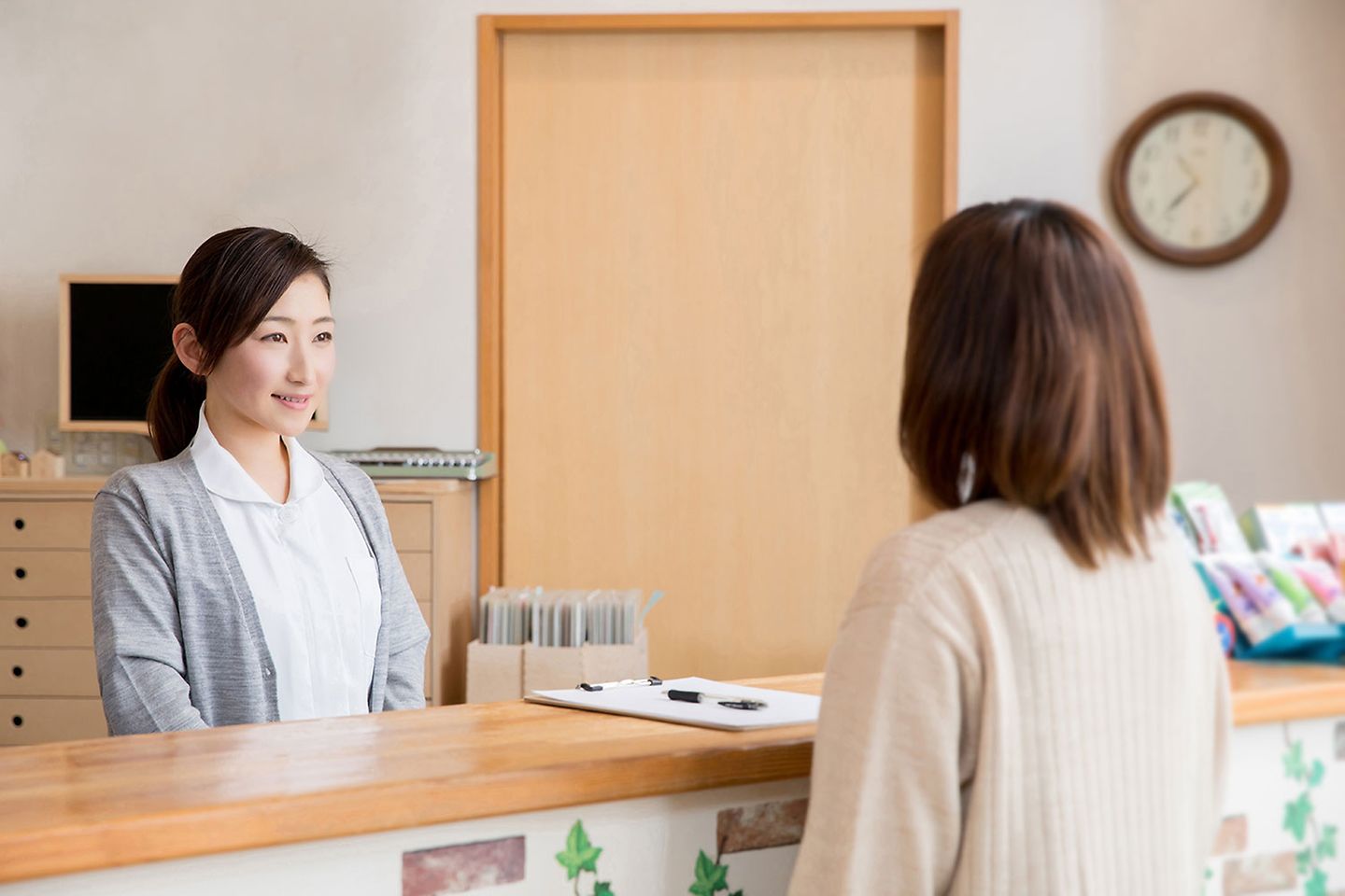 A nurse attends to a patient inquiry.