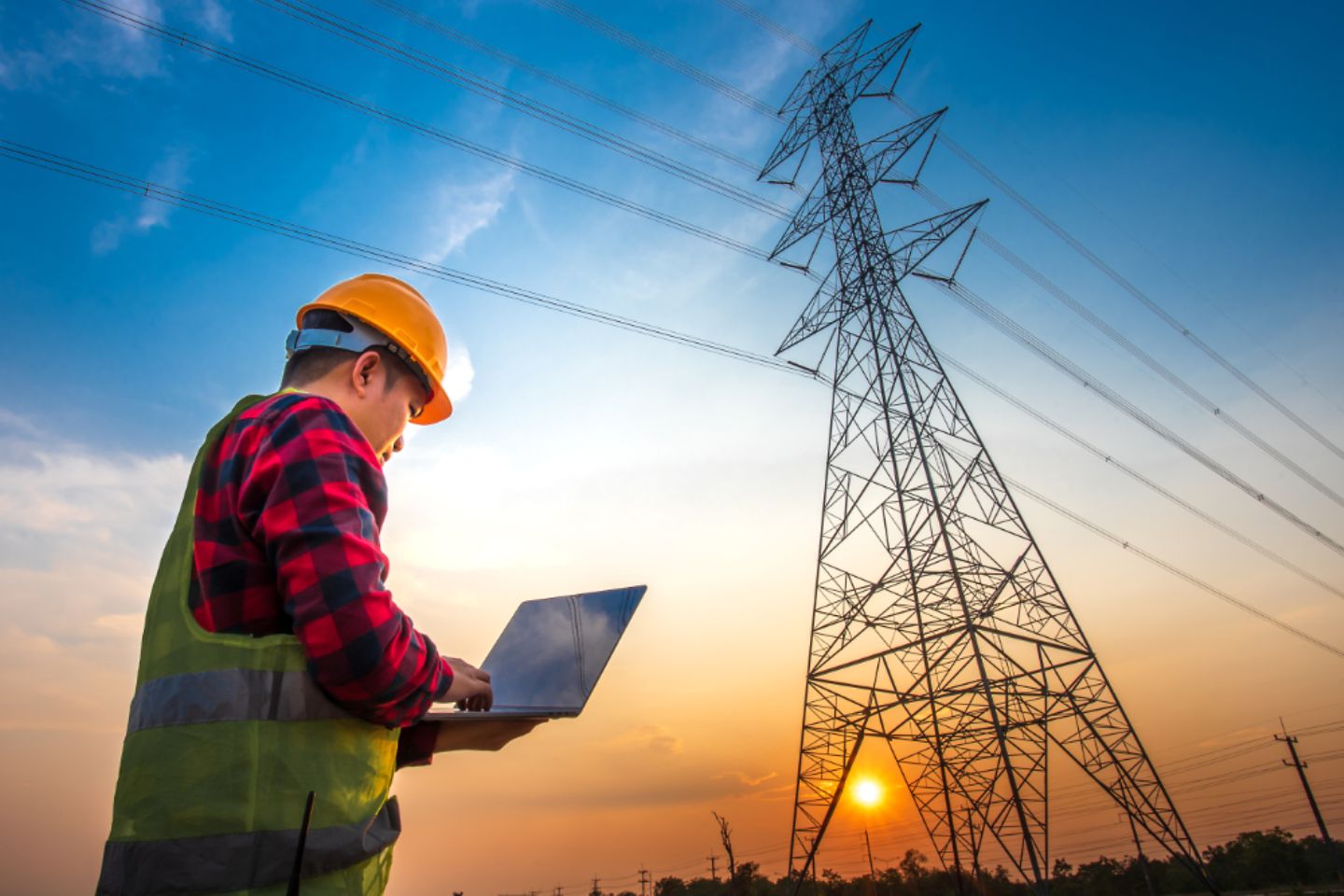 electrical engineer stands at a power station looking at the power generation planning work 