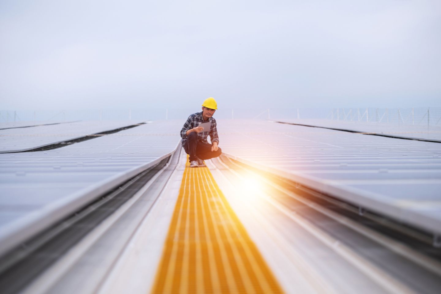 Asian engineer using tablet checking in solar power system