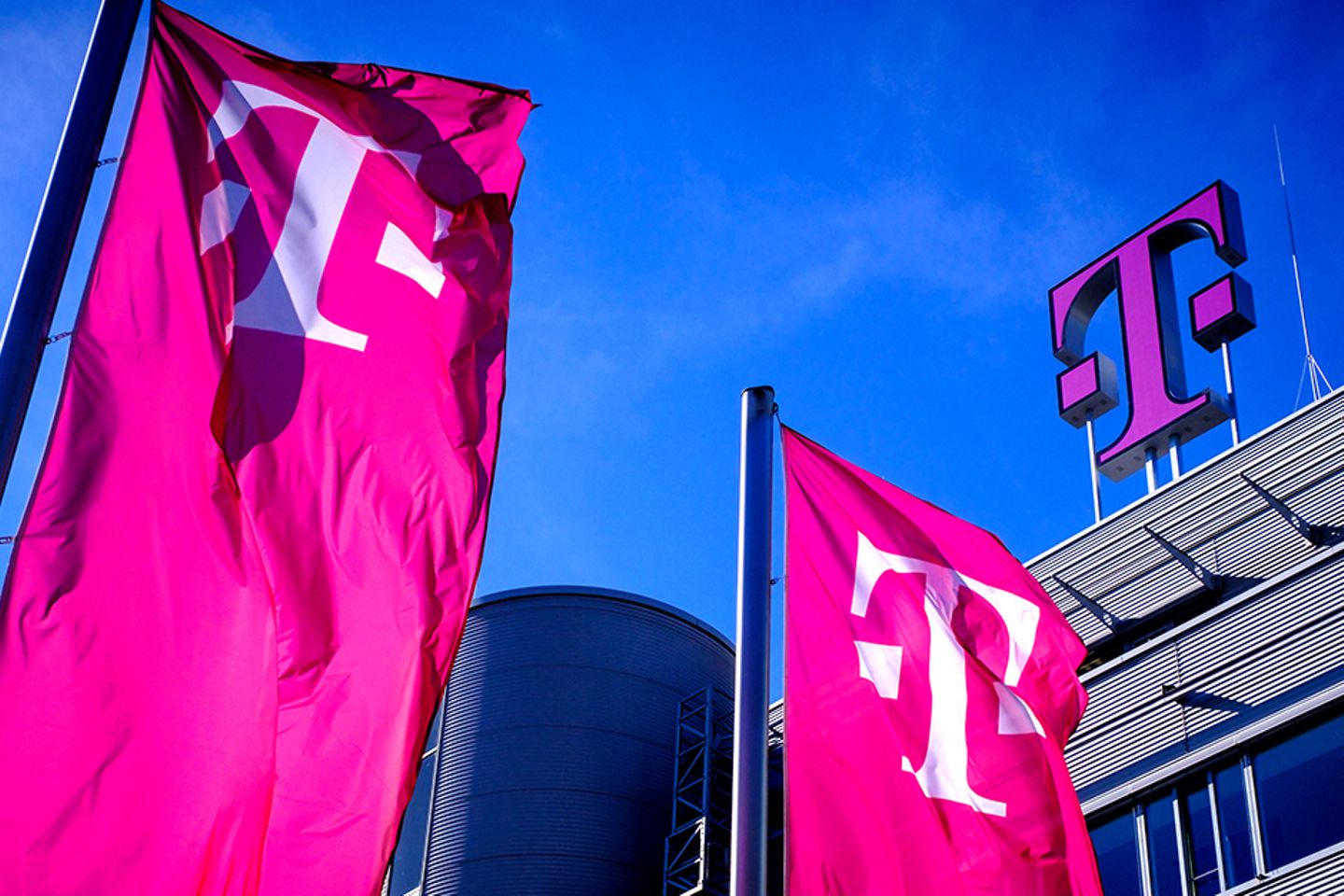 Banderas de Telekom delante de un edificio de Telekom