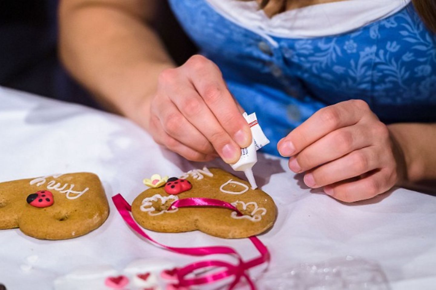 Frau verziert ein Lebkuchenherz