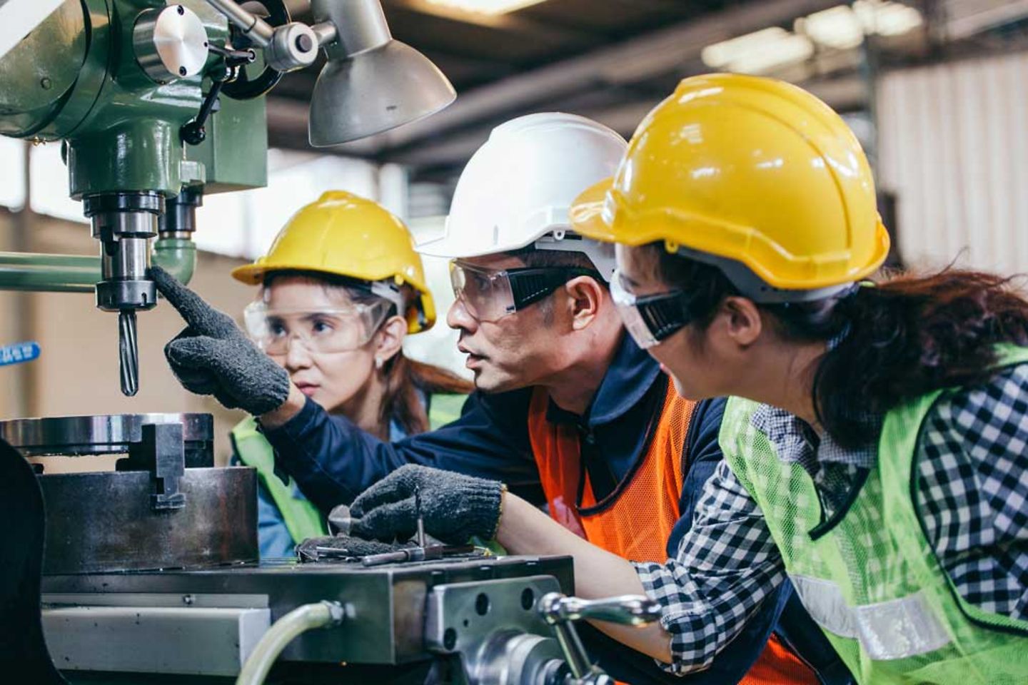 engineers learning how to work factory machine