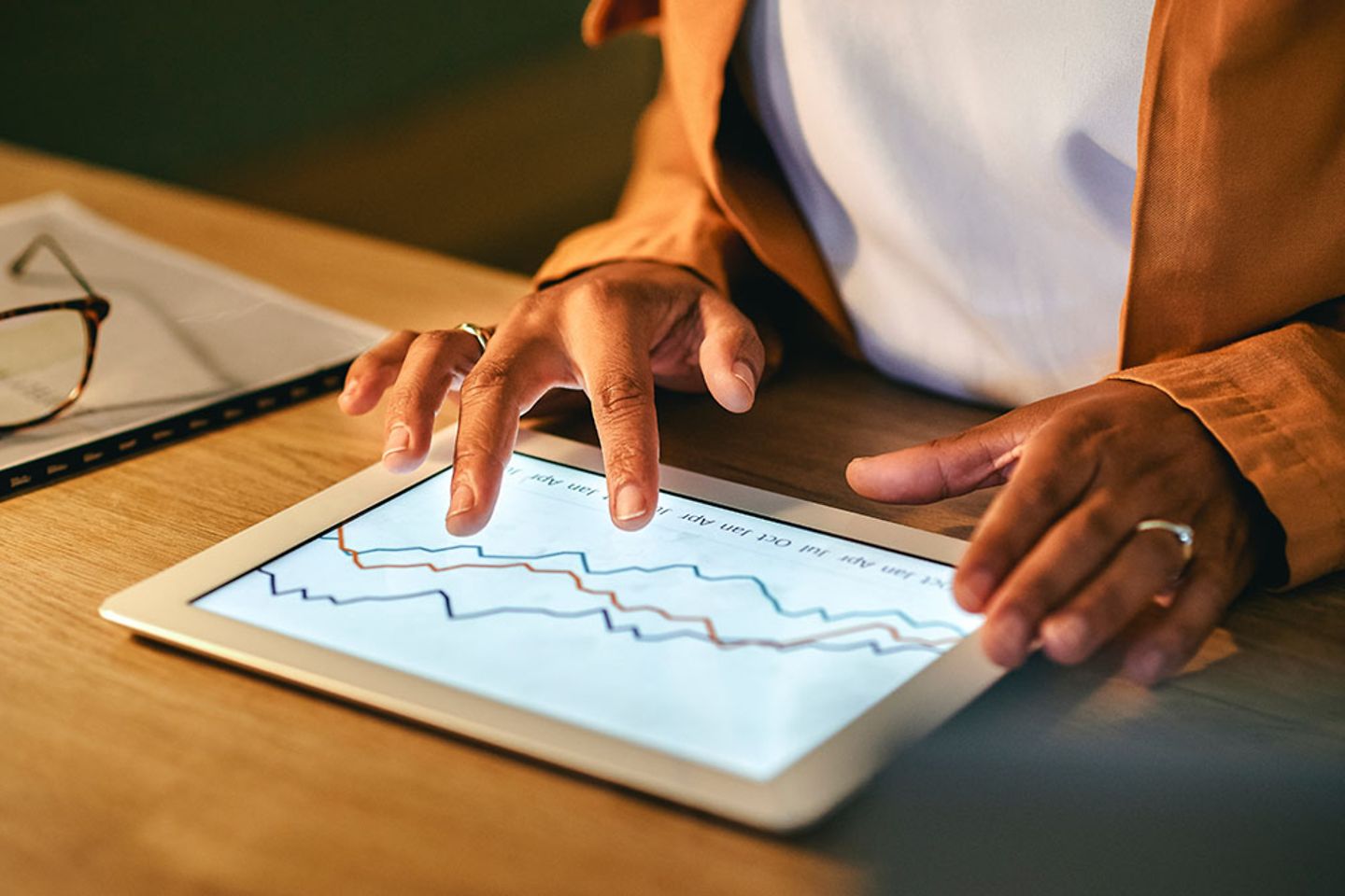 Frau benutzt Tablet mit Diagrammen