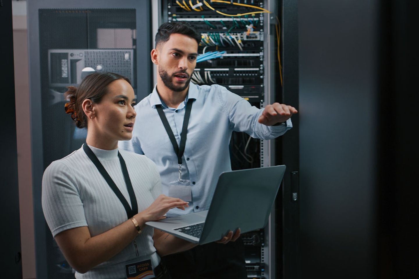 2 Colleagues standing in a Server Room.