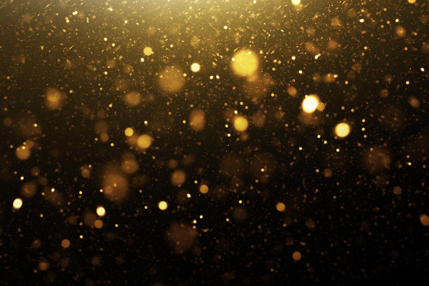 gold particles on black background