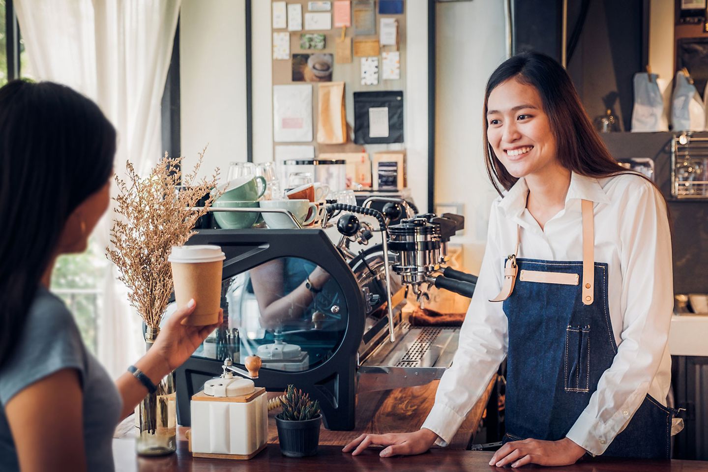 Woman serving coffee in a cafe