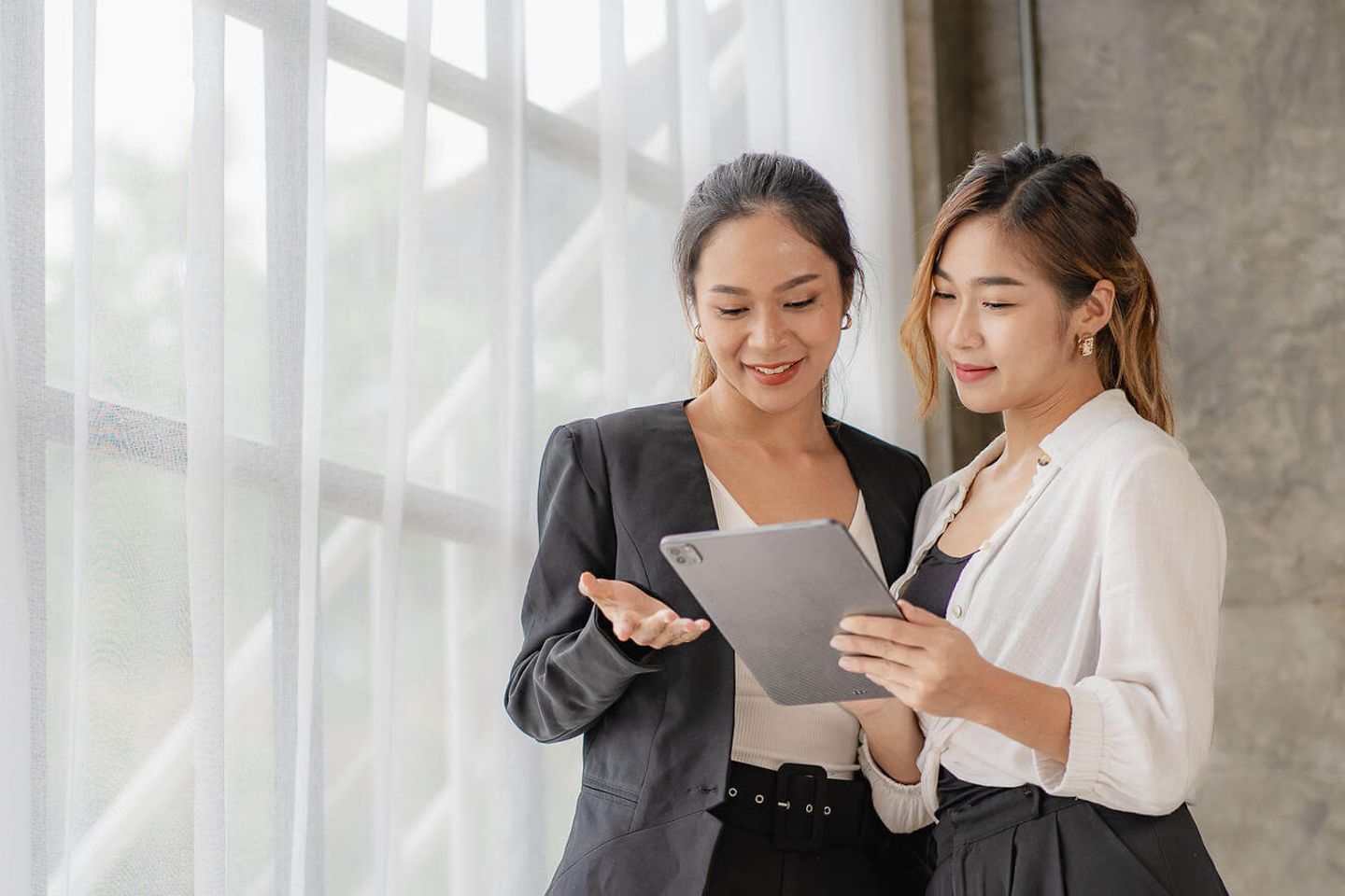 Zwei Frauen schauen auf ein Tablet