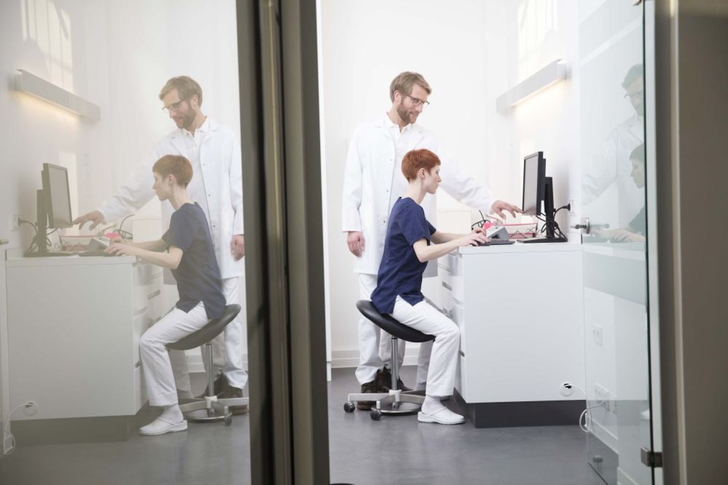 Doctor and nurse checking digital patient data in the hospital on computer on telematics infrastructure