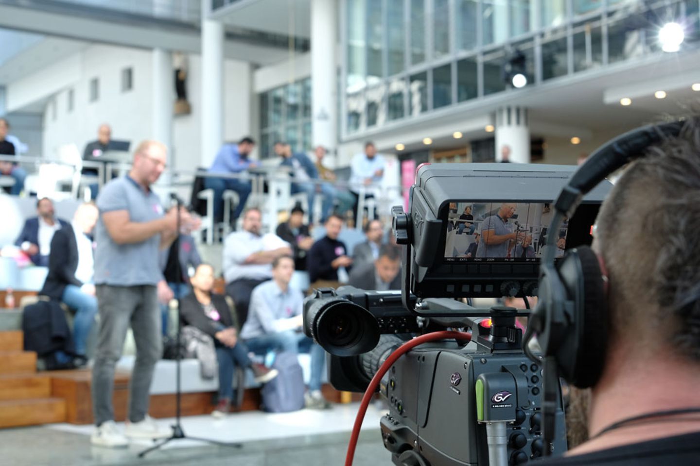 Manifestation sur les découvertes automobiles, cameraman face au public