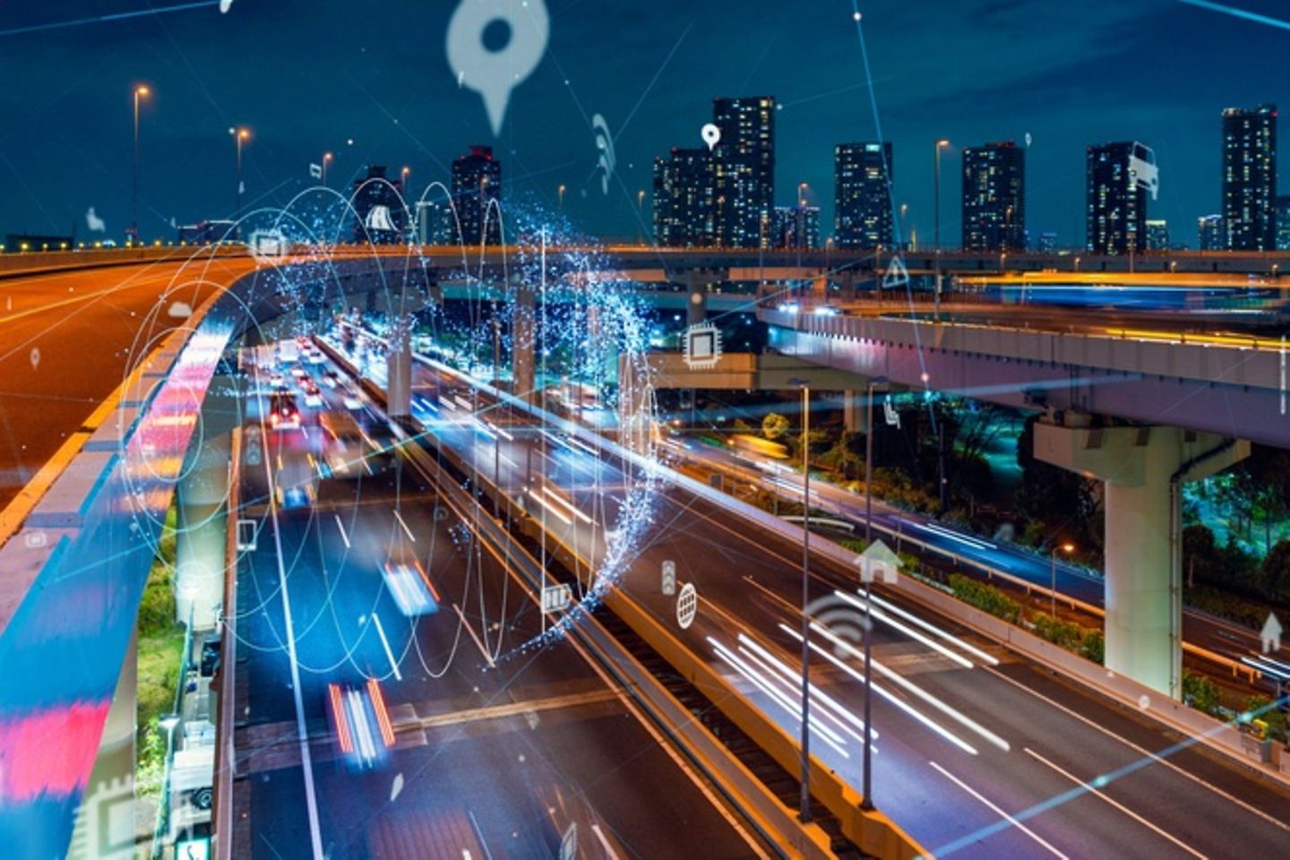 Different tyre tracks at night in front of a skyline on which bright spots and icons are visible