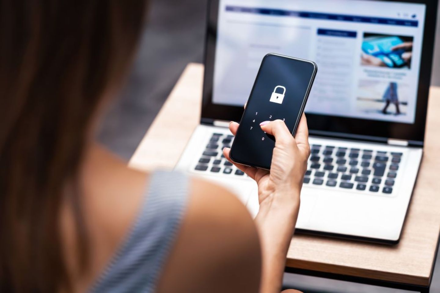 Woman in bck view using mobile phone for online banking