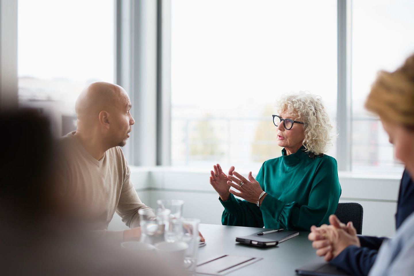 Business meeting with several people at a conference table.