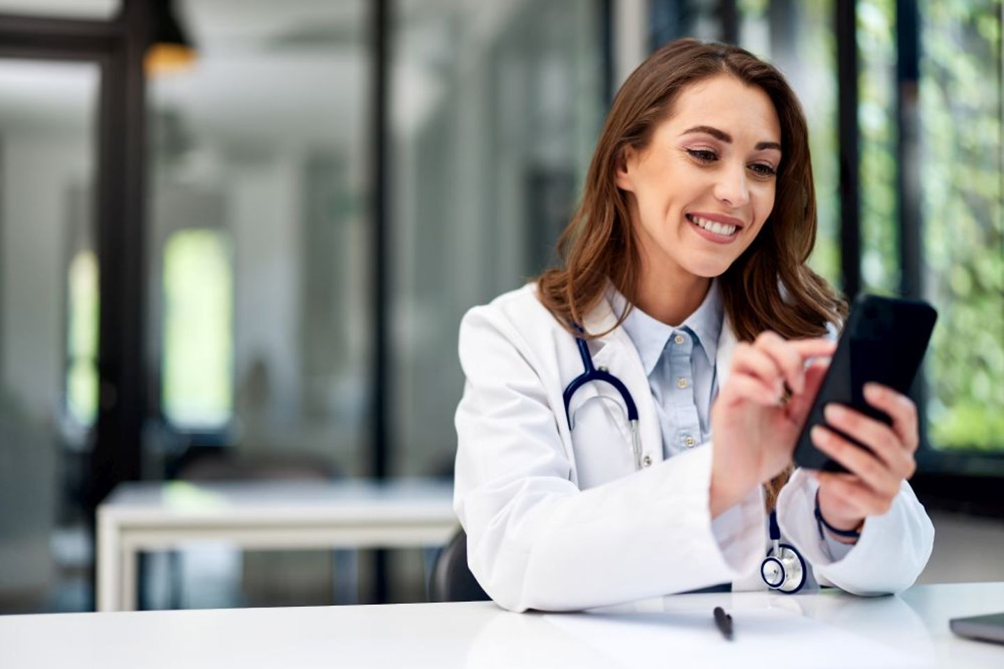 Doctor sending encrypted confidential health documents to her patient from her mobile phone