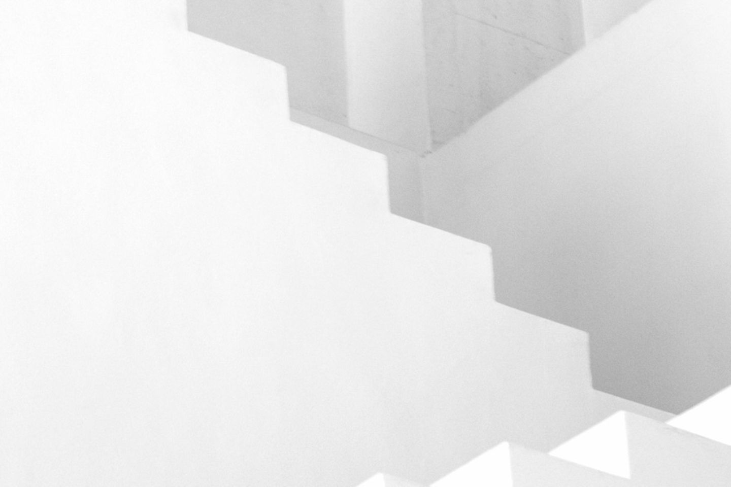Weiß-graue Treppe vor weißem Hintergrund