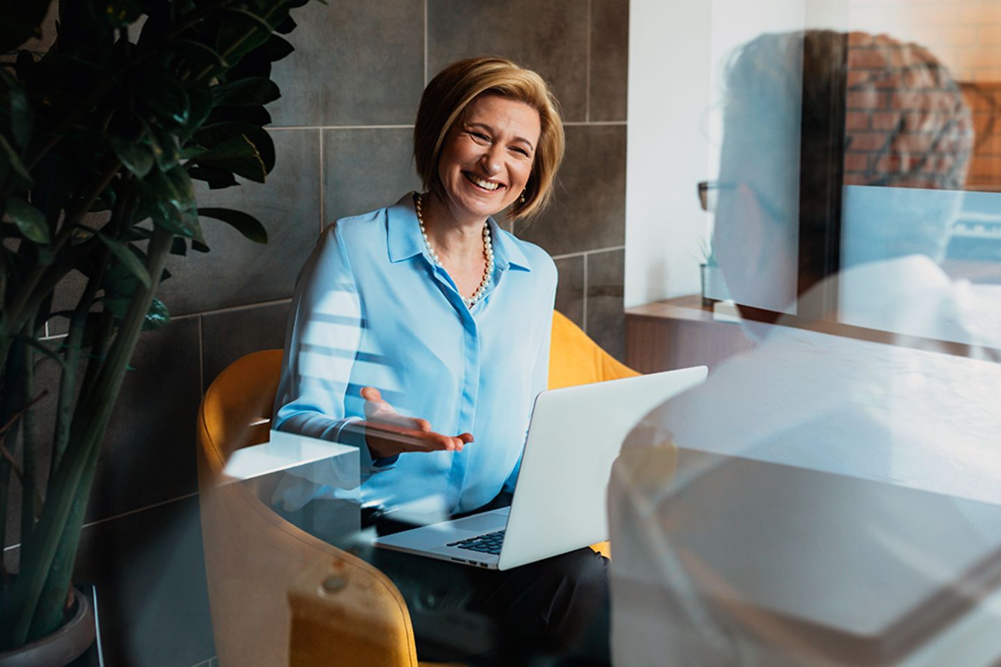 Cheerful bank clerk chatting with her customer