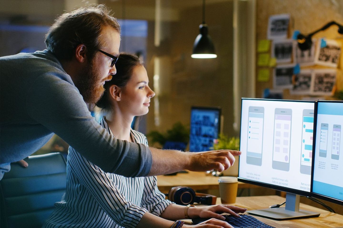 Two people in front of the screen