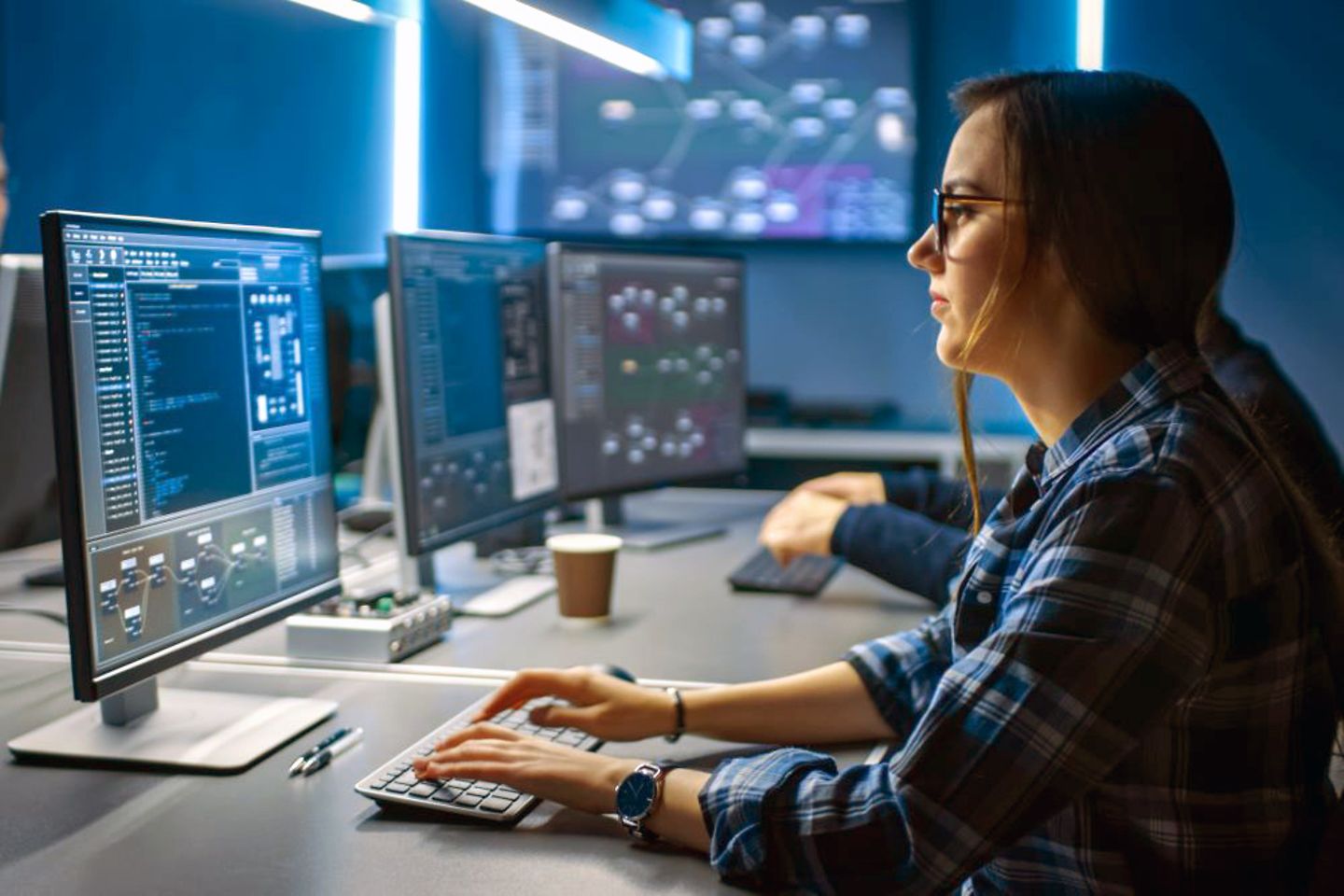 Young cyber security analyst in front of a monitor in the Security Operations Centre