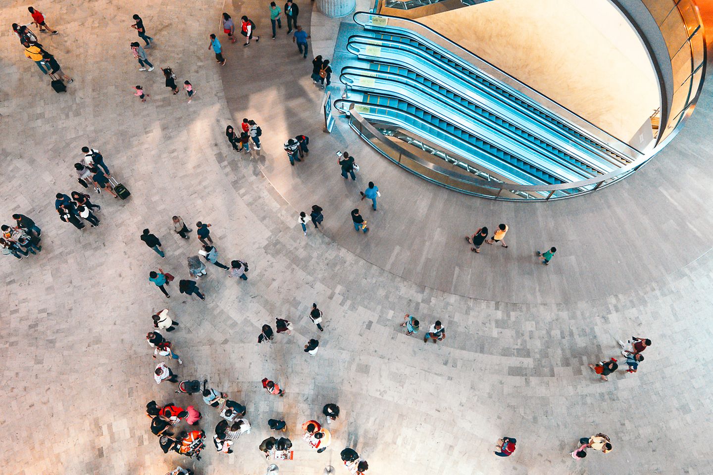 Aerial view of a busy square over which numerous people go.