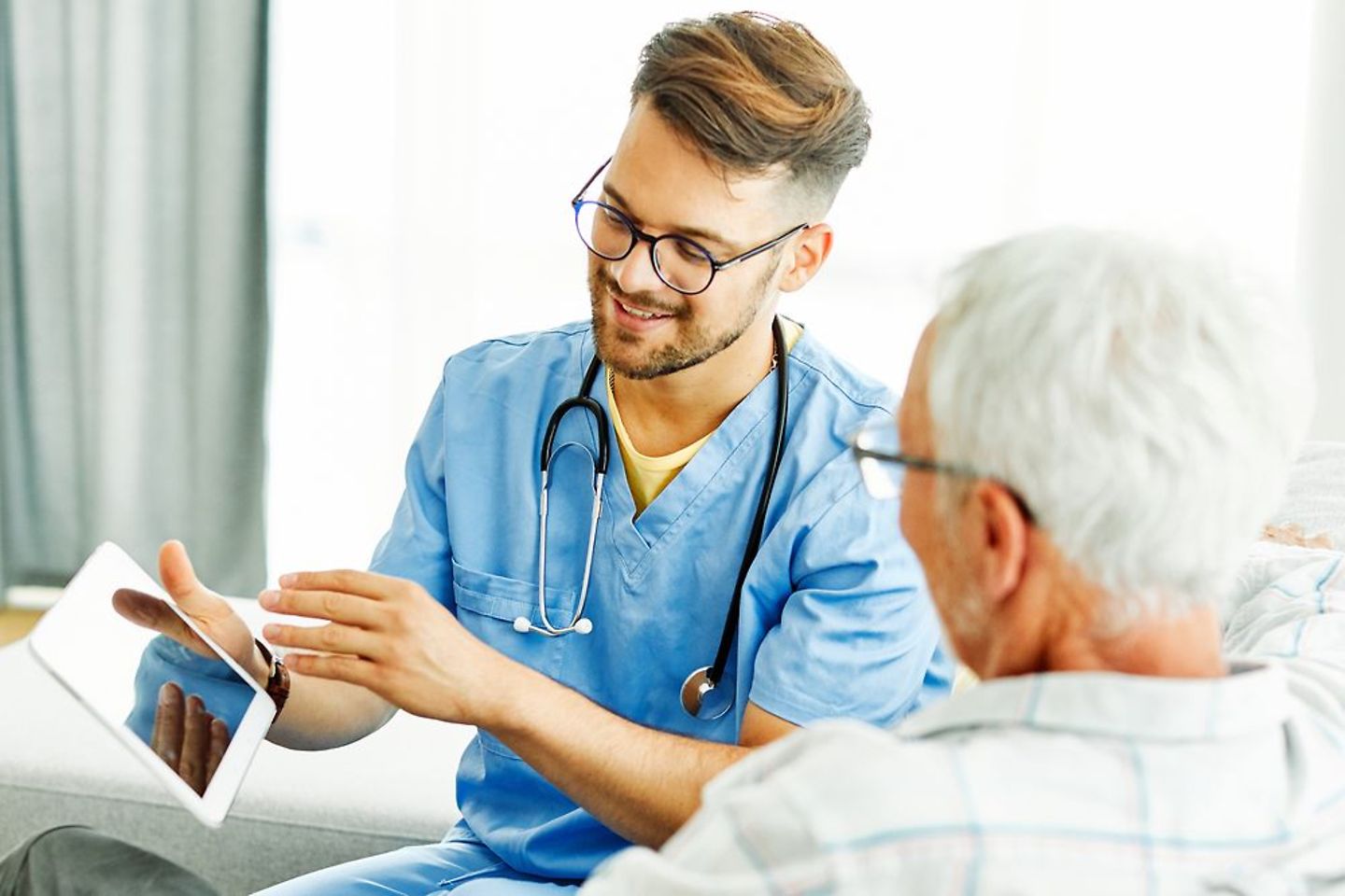 Doctor explains dementia therapy app to a patient