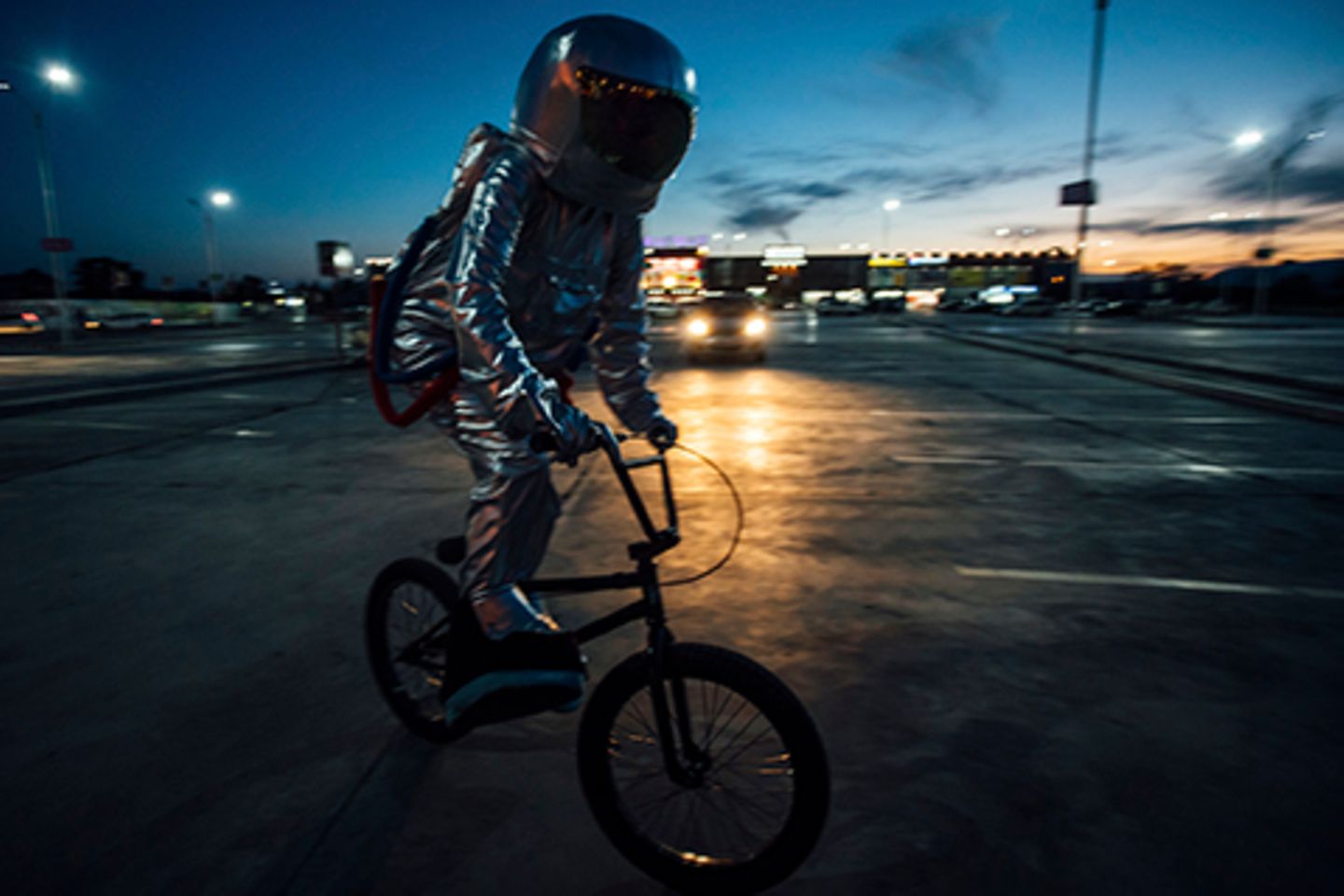 BMX rider with AR helmet on night road.