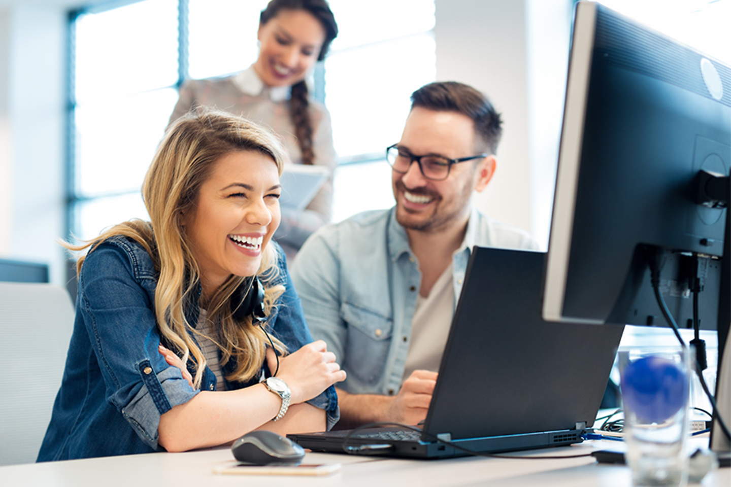 Mitarbeiter sehen gemeinsam auf den Computer