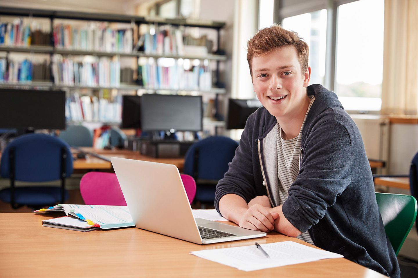 Student sits in front of the laptop and learns